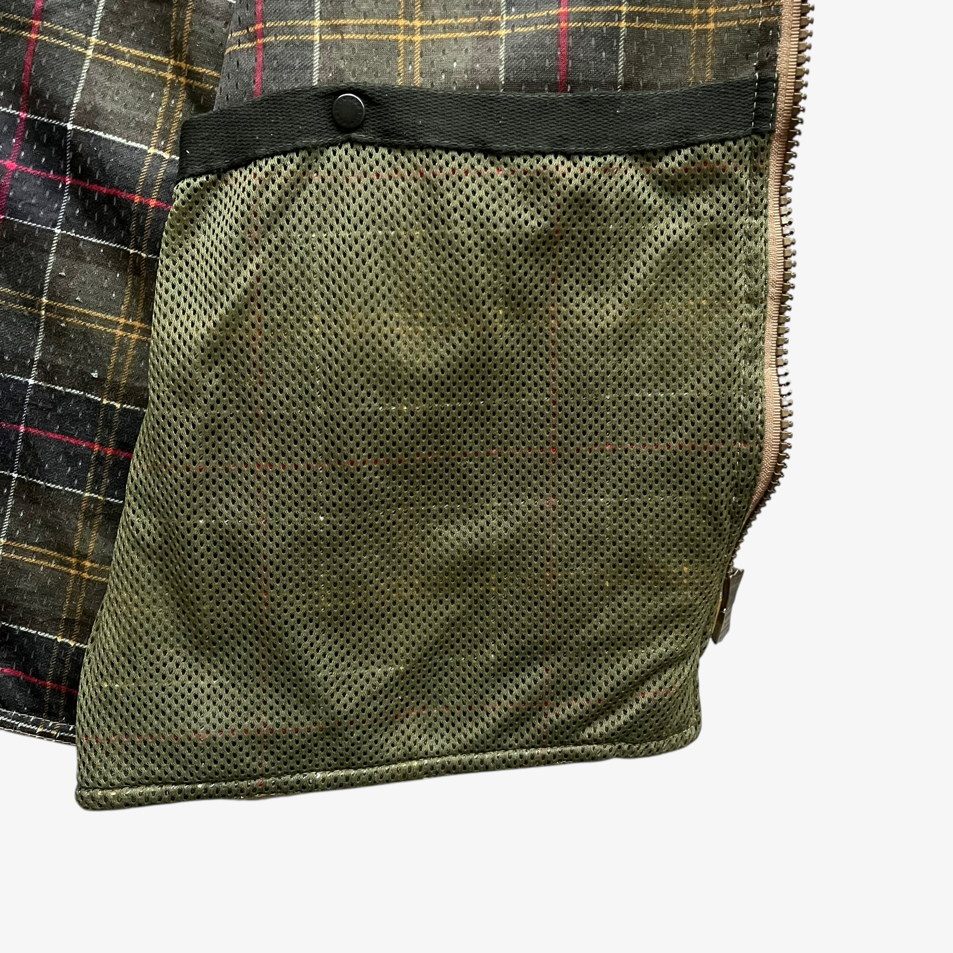 Inside buttoned pocket of vintage Y2K men's Barbour lime green quilted jacket.