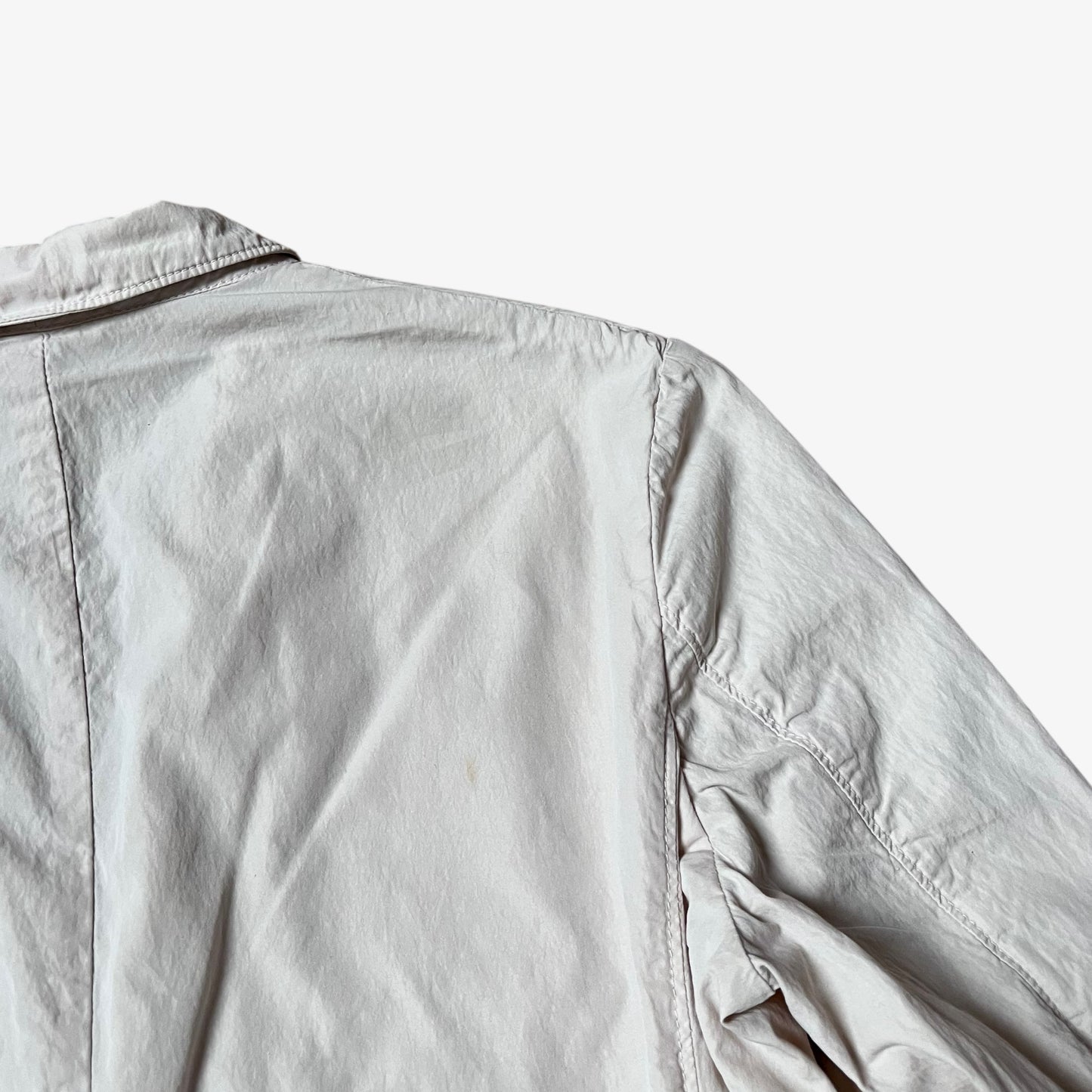 Back patina on vintage Y2K men's CP Company cream single breasted blazer.