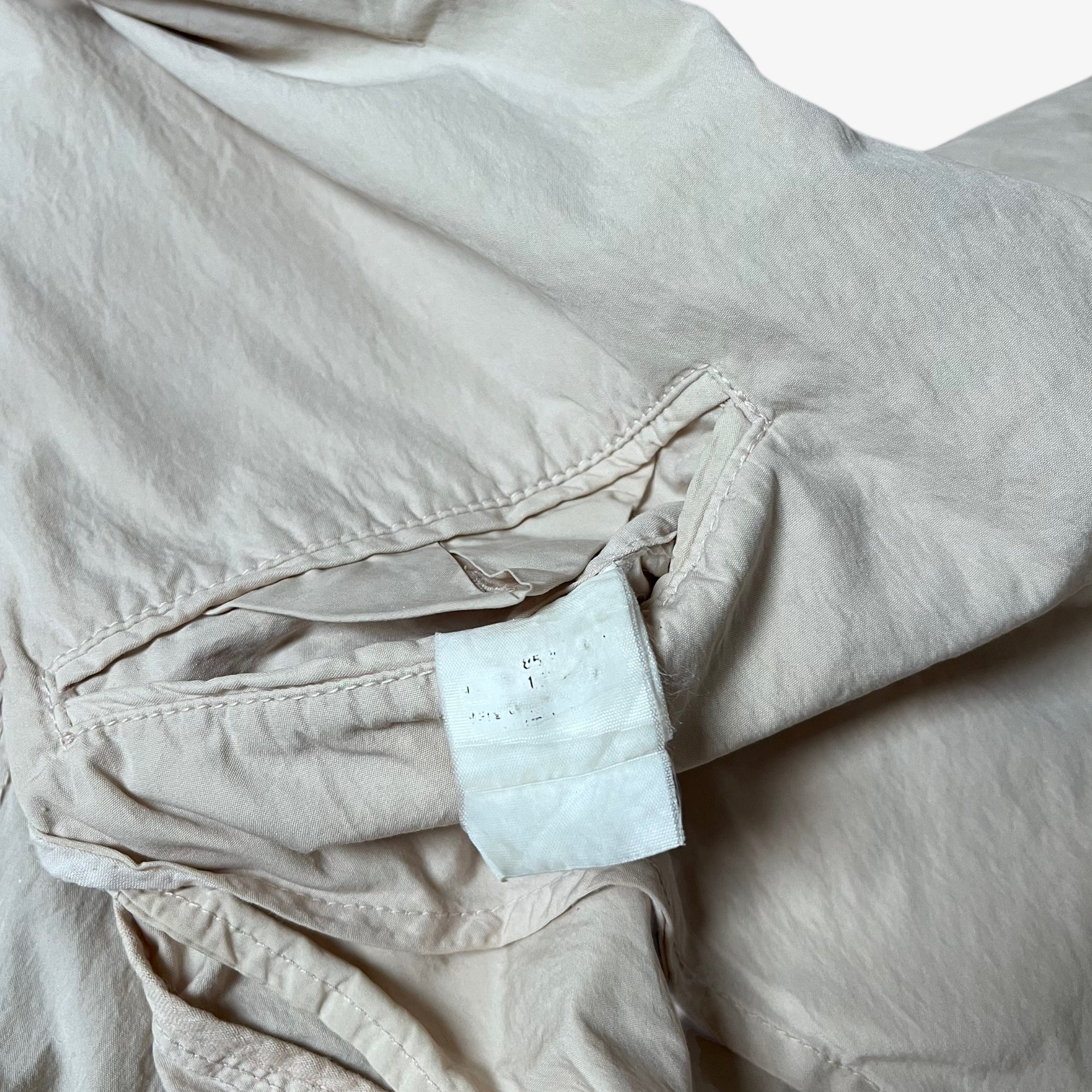 Faded inside label of vintage Y2K men's CP Company cream single breasted blazer.