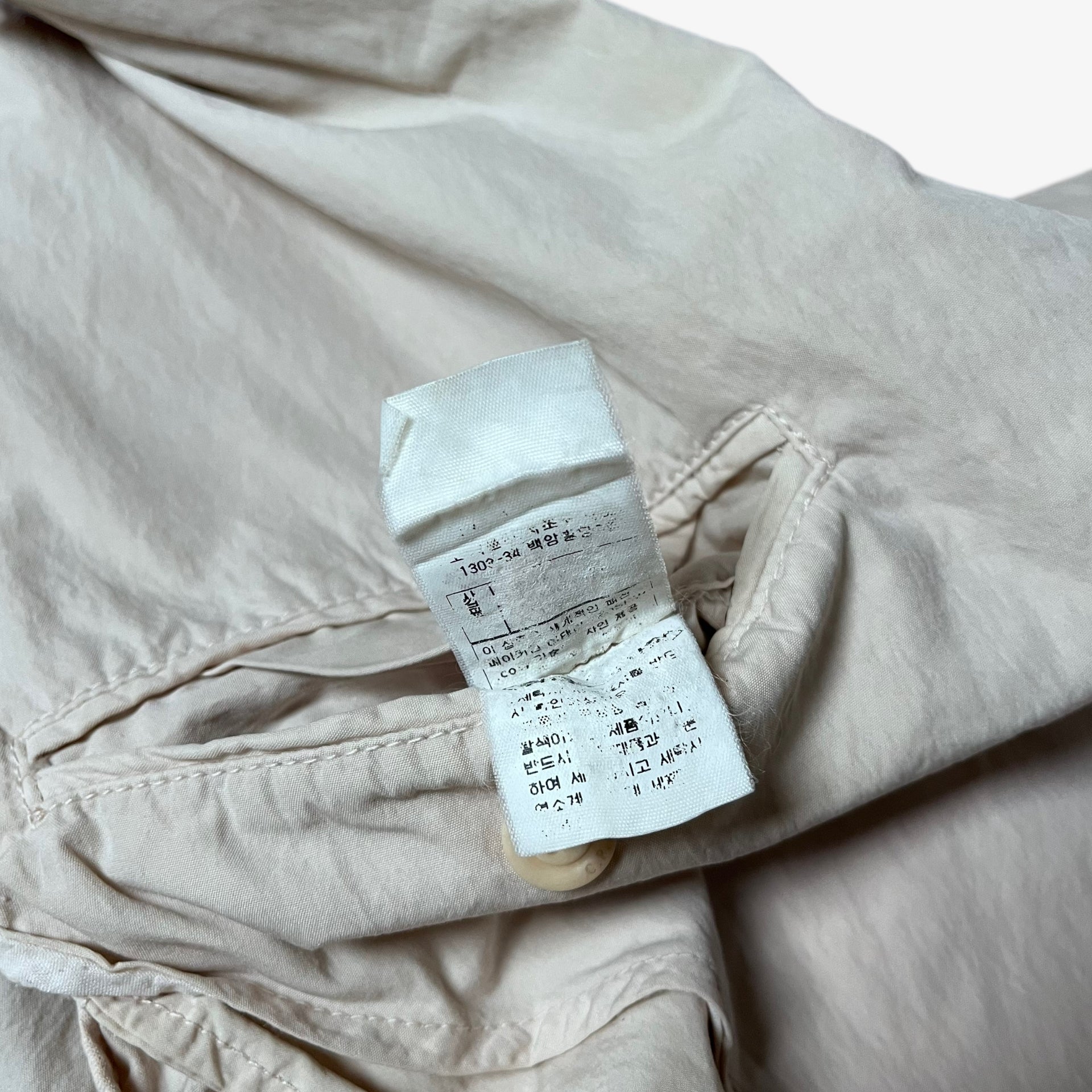 Inside label of vintage Y2K men's CP Company cream single breasted blazer.