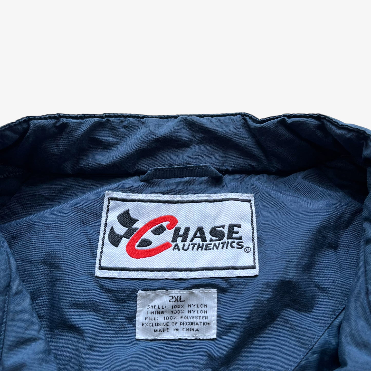 Chase Authentics label stitched inside of men's vintage Y2K 2005 team nascar blue jacket.