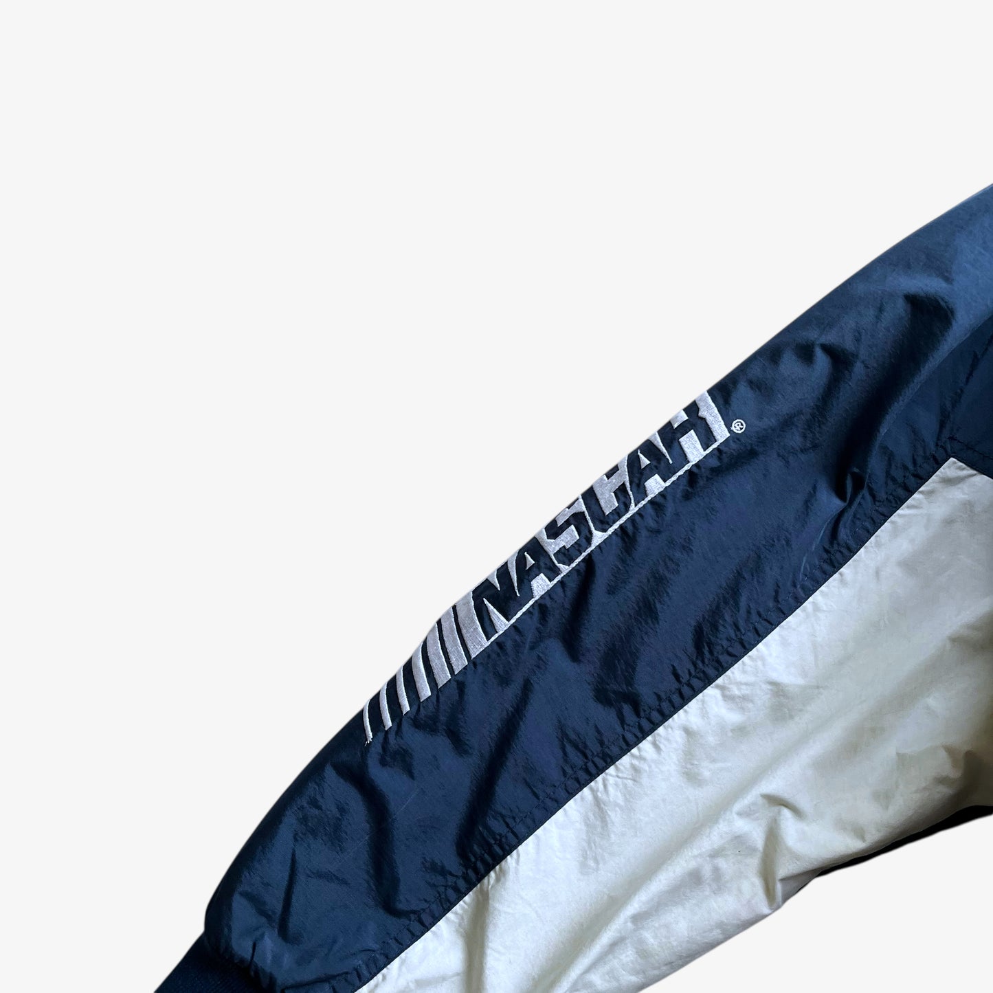 Nascar embroidered sleeve spell out on men's vintage Y2K Chase Authentics 2005 team blue jacket.