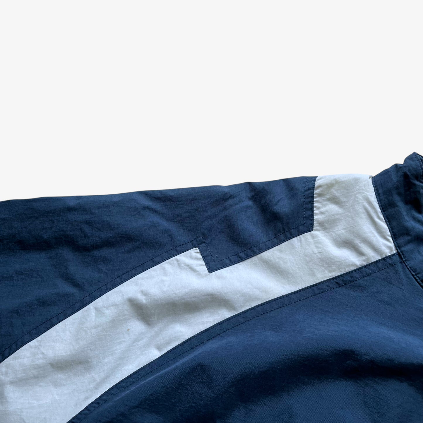 Wear on men's vintage Y2K Chase Authentics 2005 team nascar blue jacket.