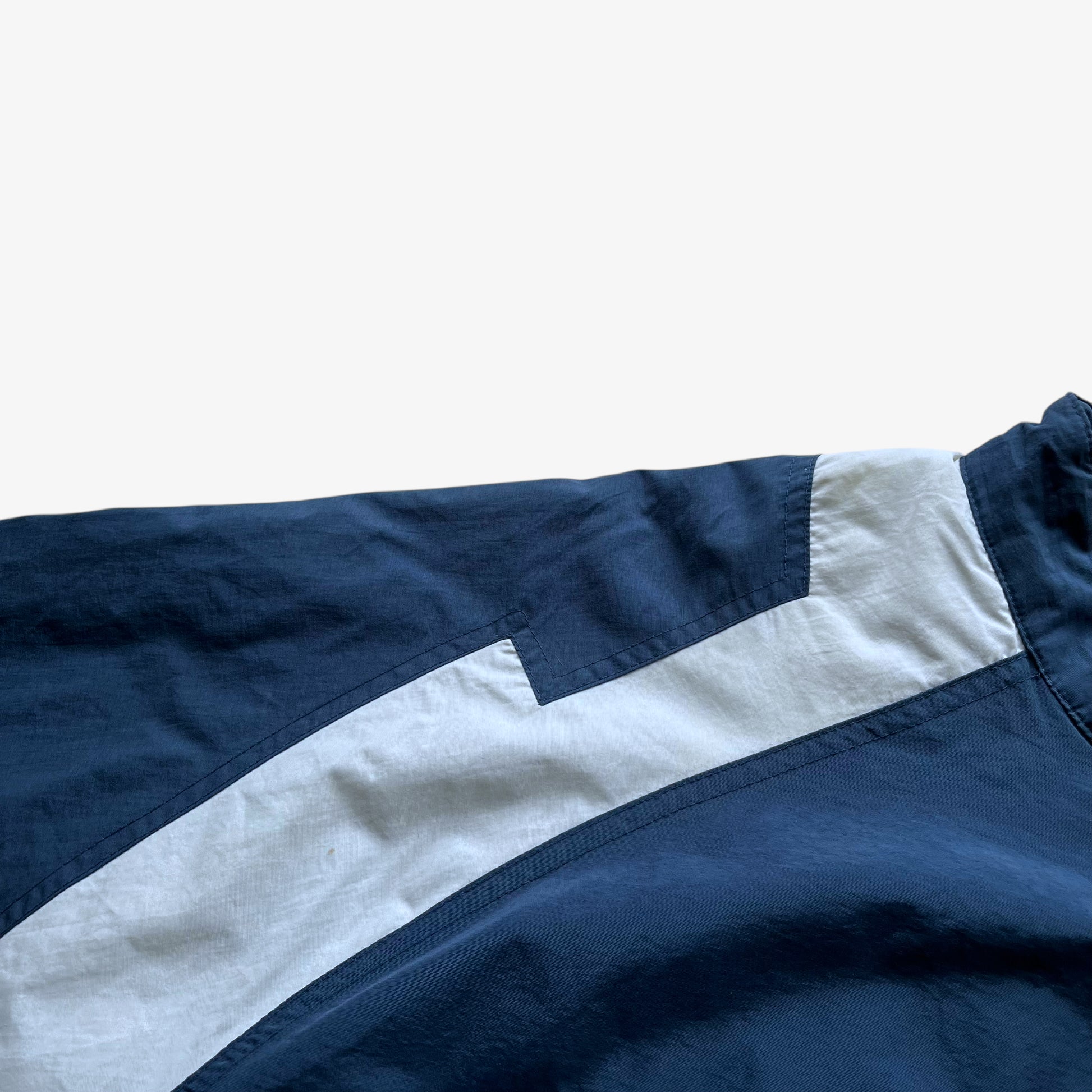 Wear on men's vintage Y2K Chase Authentics 2005 team nascar blue jacket.