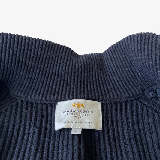 Close up of a Hawes and Curtis label stitched inside a vintage black quilted puffer gilet.