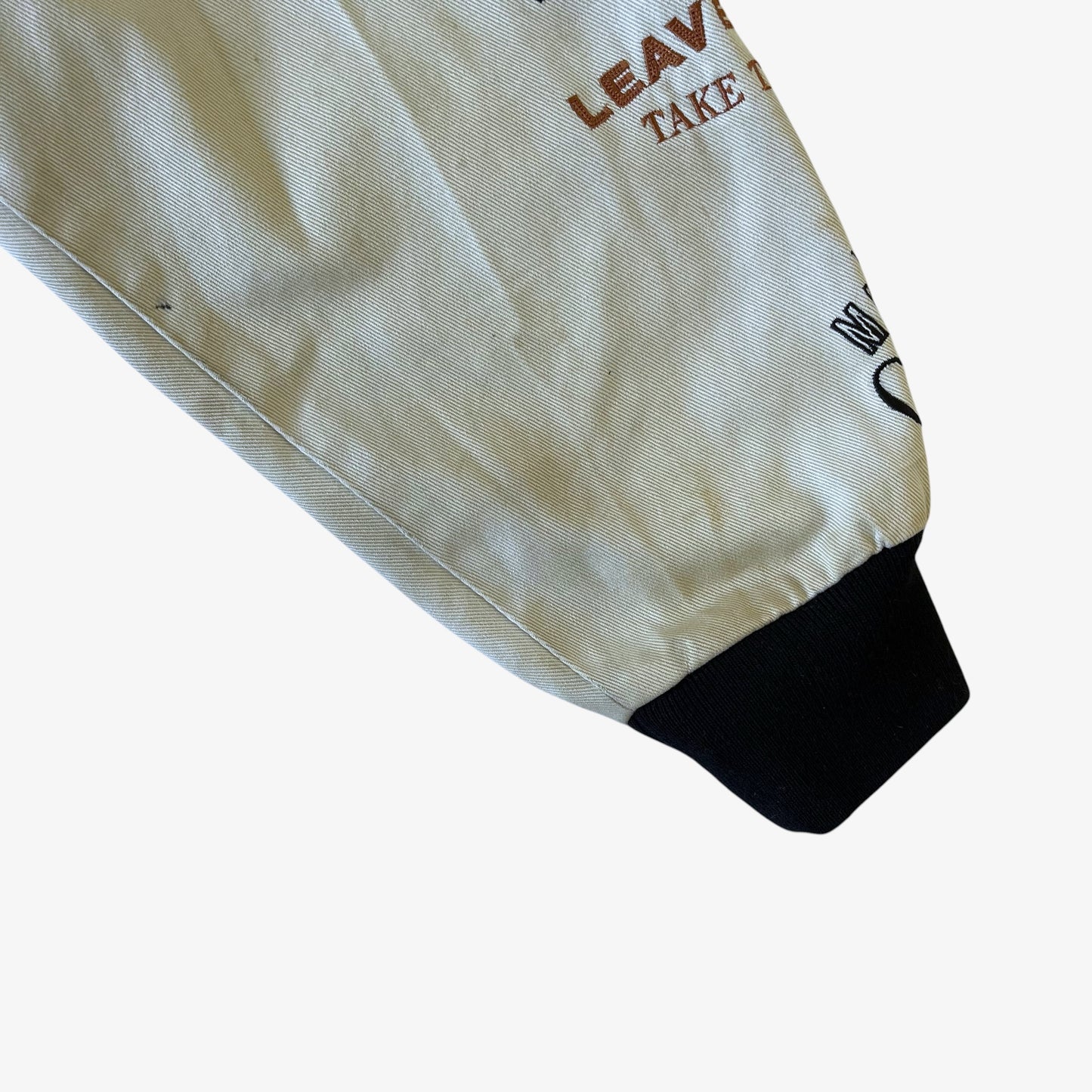Sleeve wear on a vintage Y2K Jeff Hamilton The Godfather jacket.