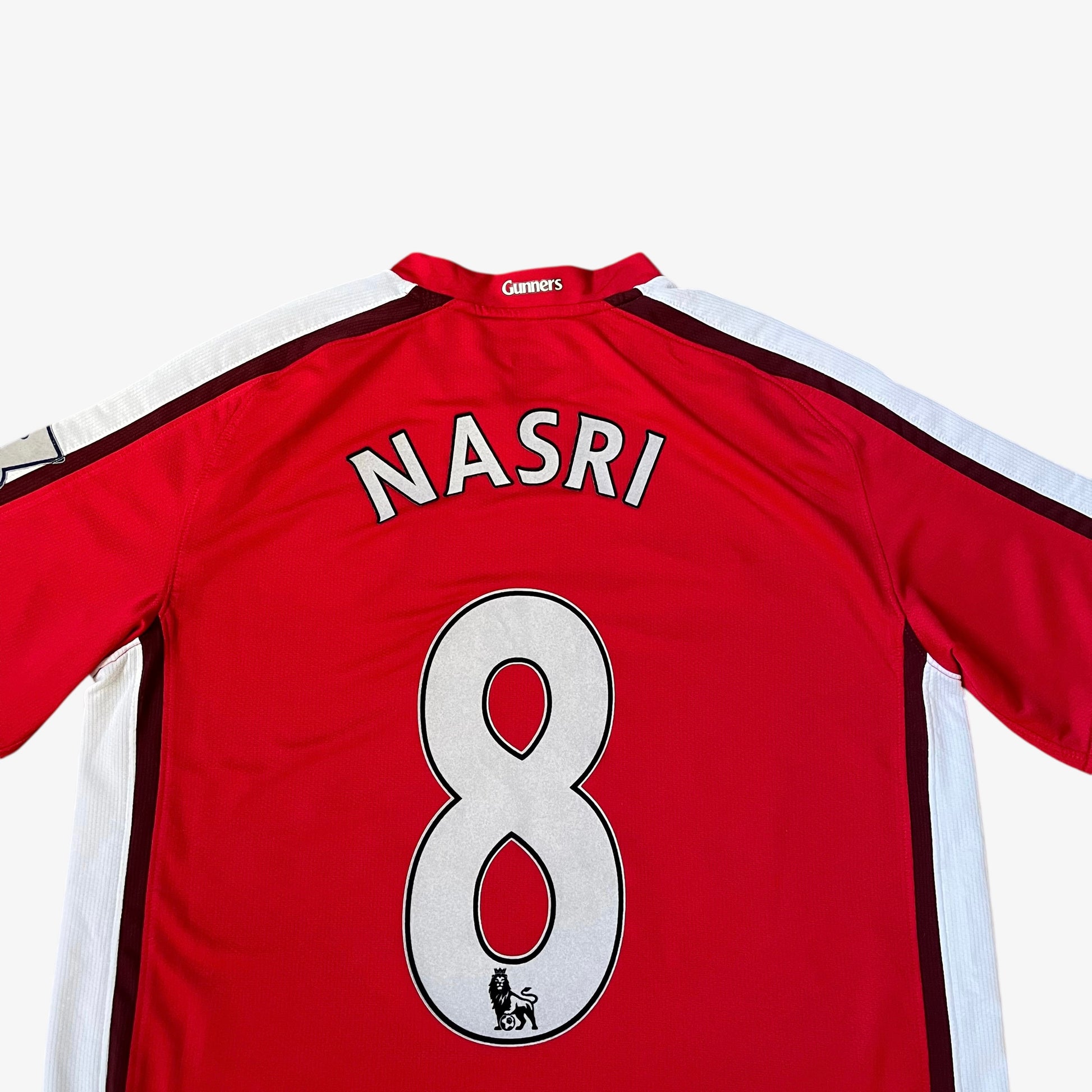 Close up of embossed Nasri 8 on the back of vintage men's Nike Arsenal 2008 - 2010 red home football jersey.