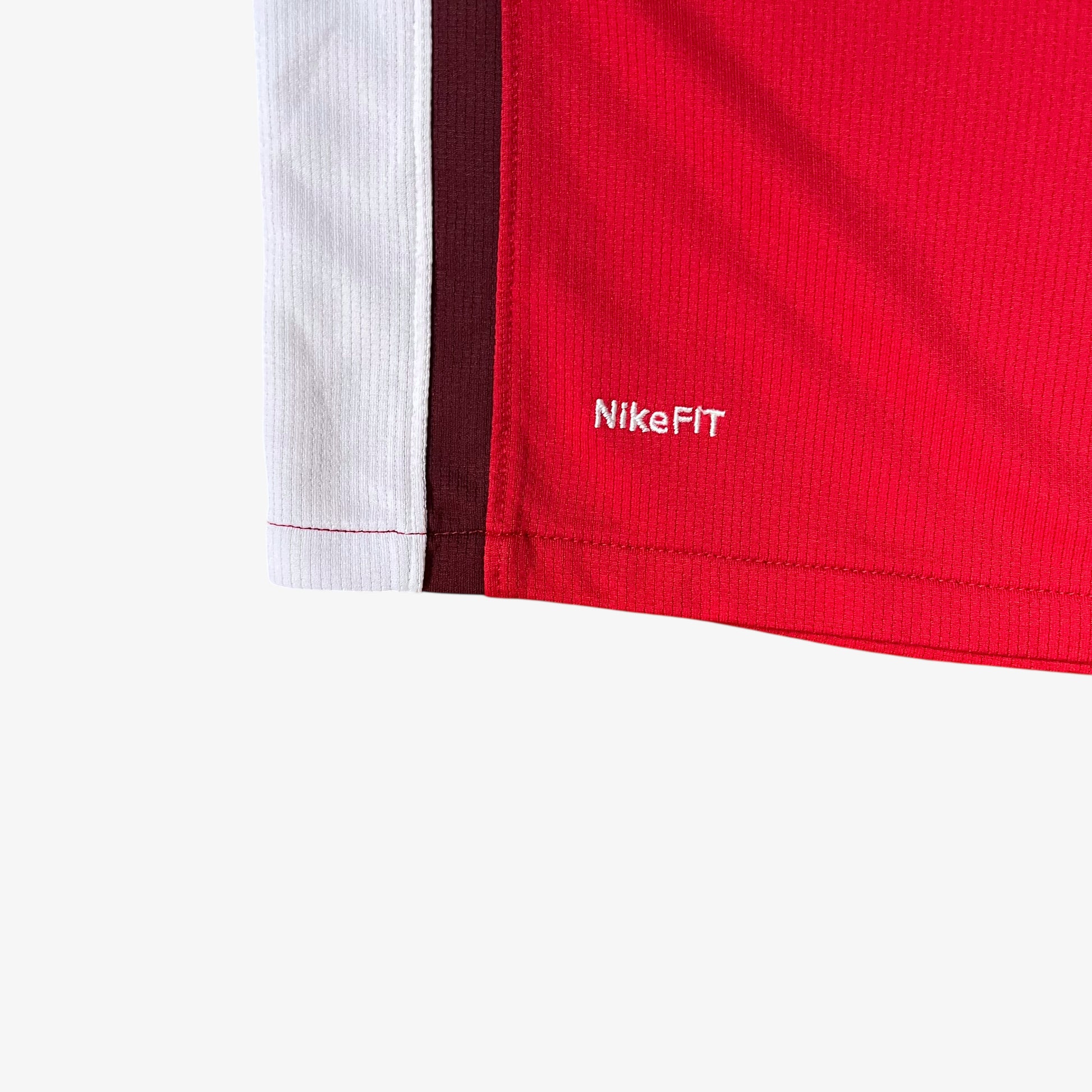 Nike Fit embroidered logo on the hem of vintage men's Arsenal 2008 - 2010 red home football jersey.