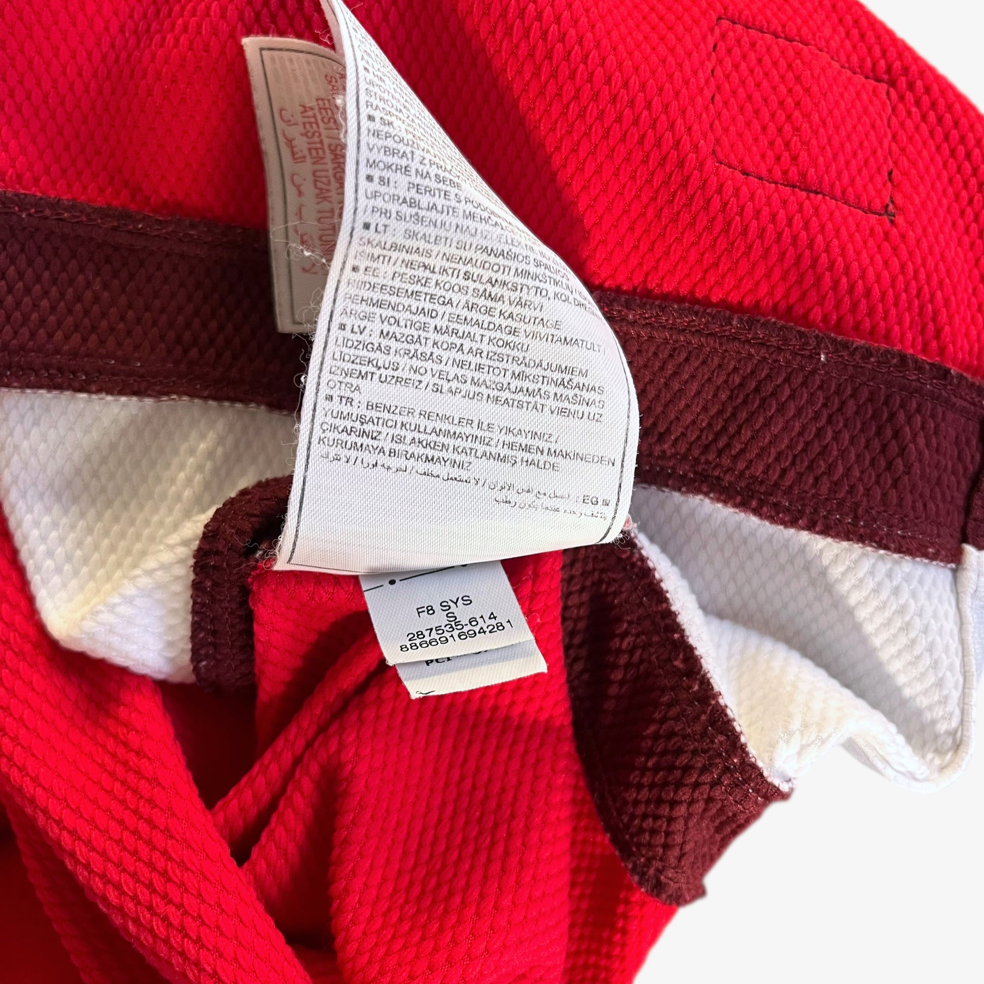 Inside labels of vintage men's Nike Arsenal 2008 - 2010 red home football jersey.