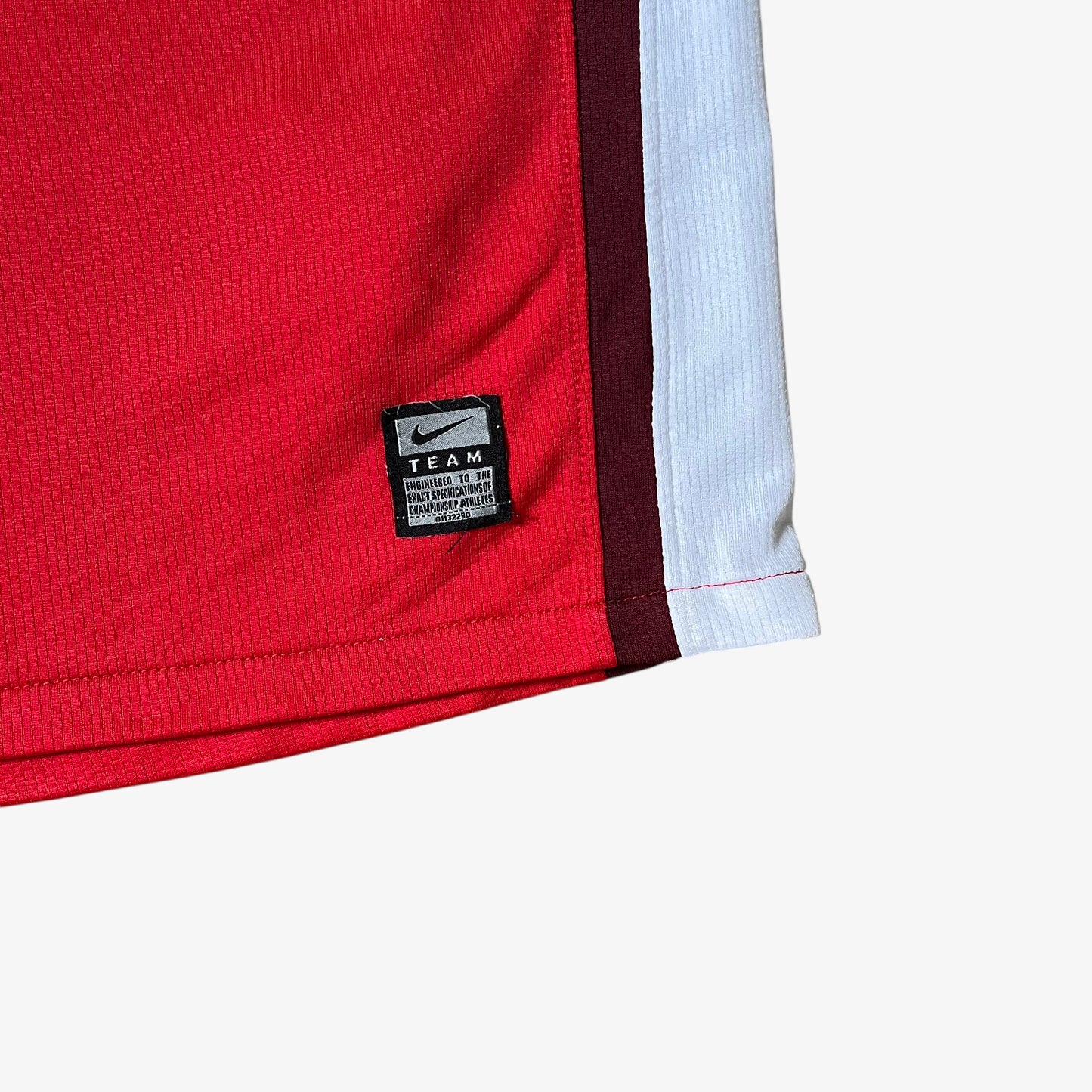 Nike team tag embroidered on the hem of vintage men's Arsenal 2008 - 2010 red home football jersey.