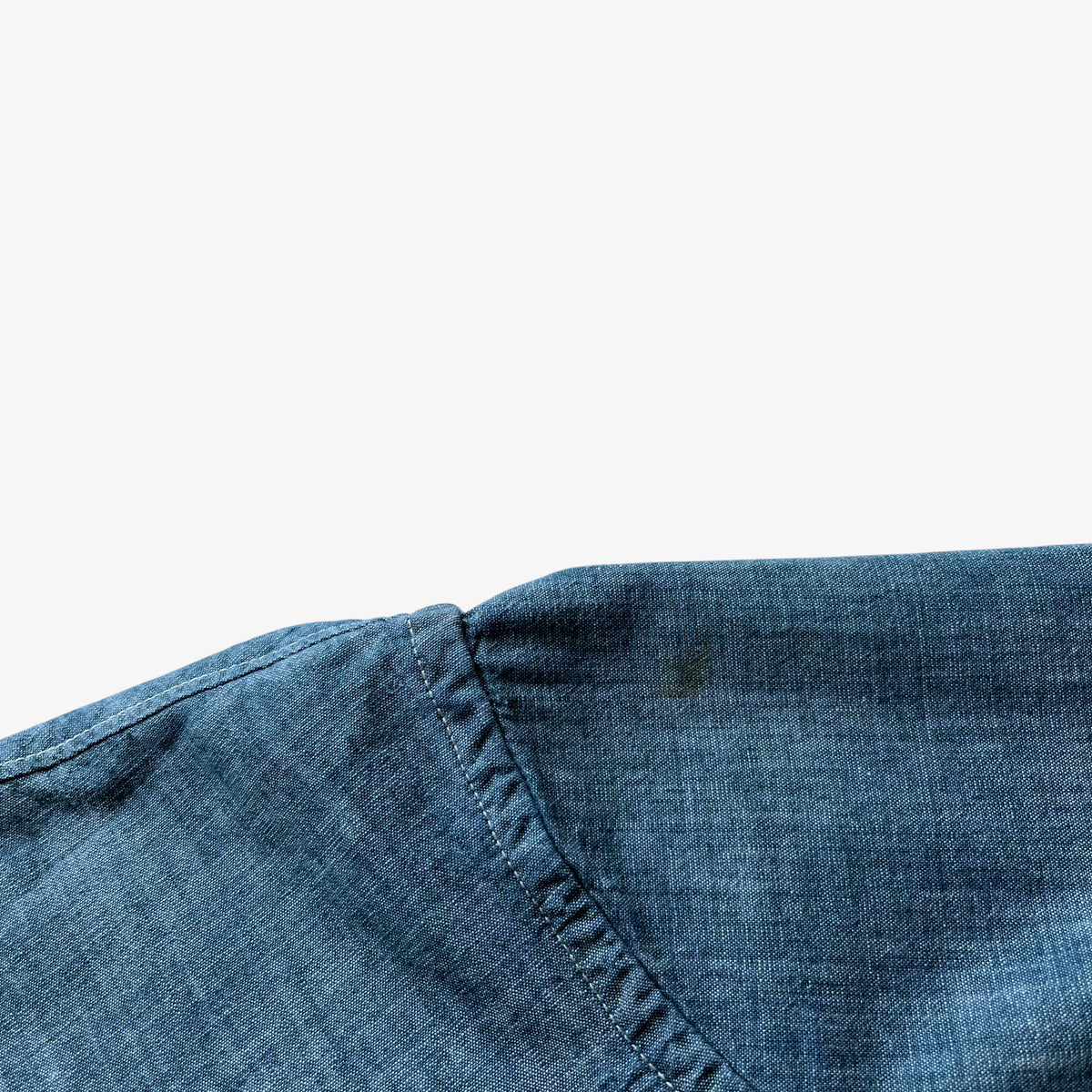 Close up of wear on the shoulder of a vintage men's Paul Smith denim shirt.