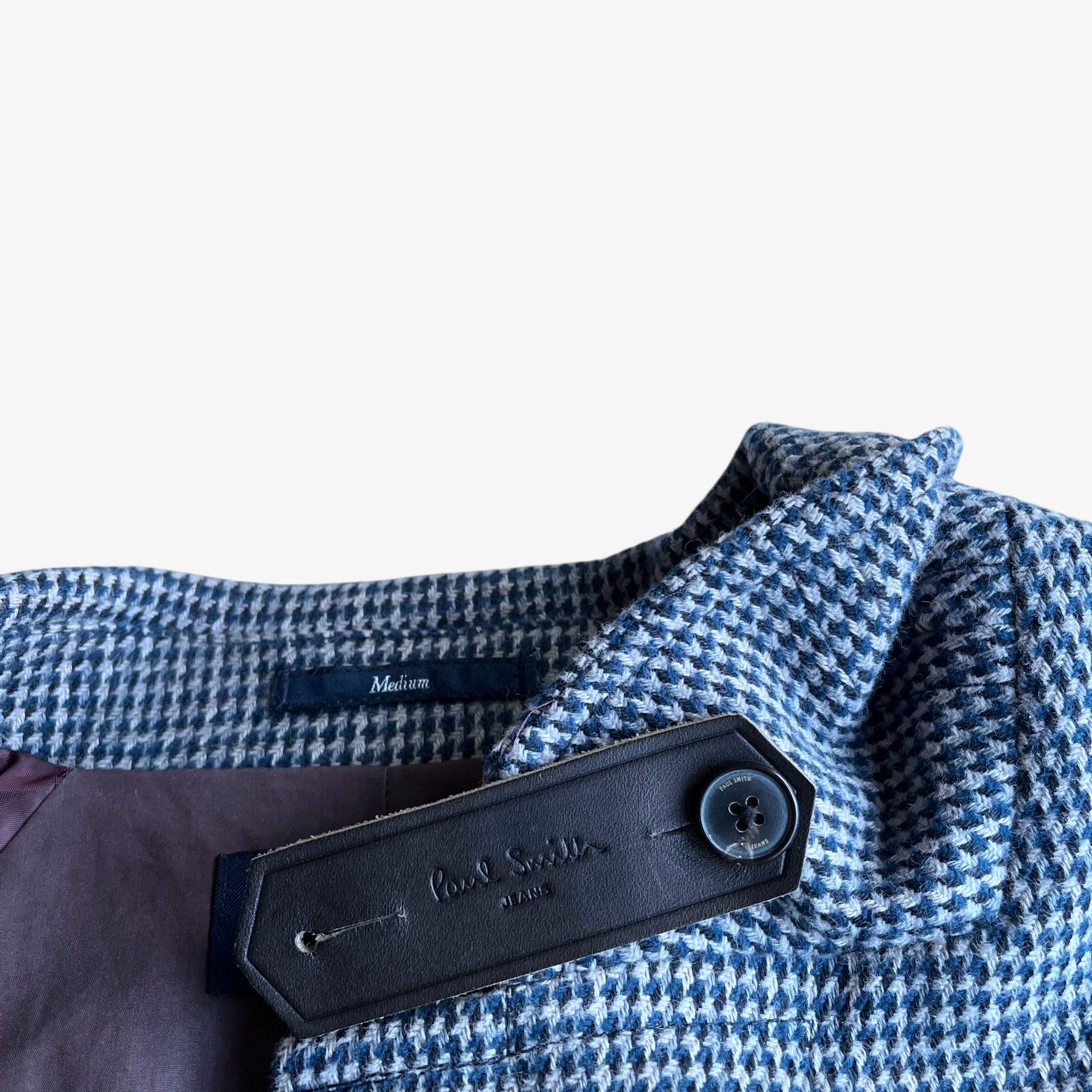 Paul Smith jeans leather brand tag on vintage Y2K men's blue and grey houndstooth print double breasted coat.