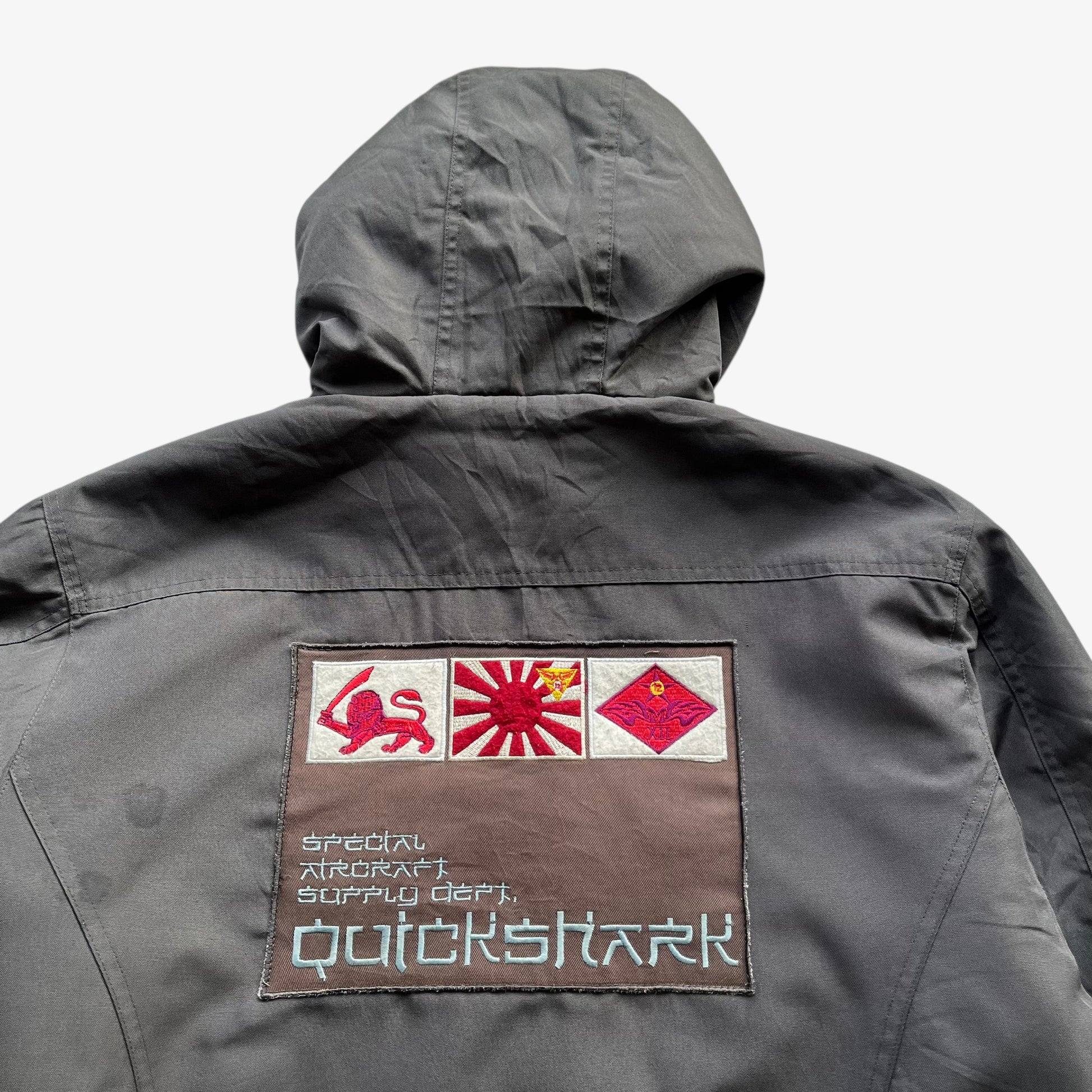 Embroidered back spell out flag on men's vintage Y2K Quickshark special aircraft supply grey utility jacket.
