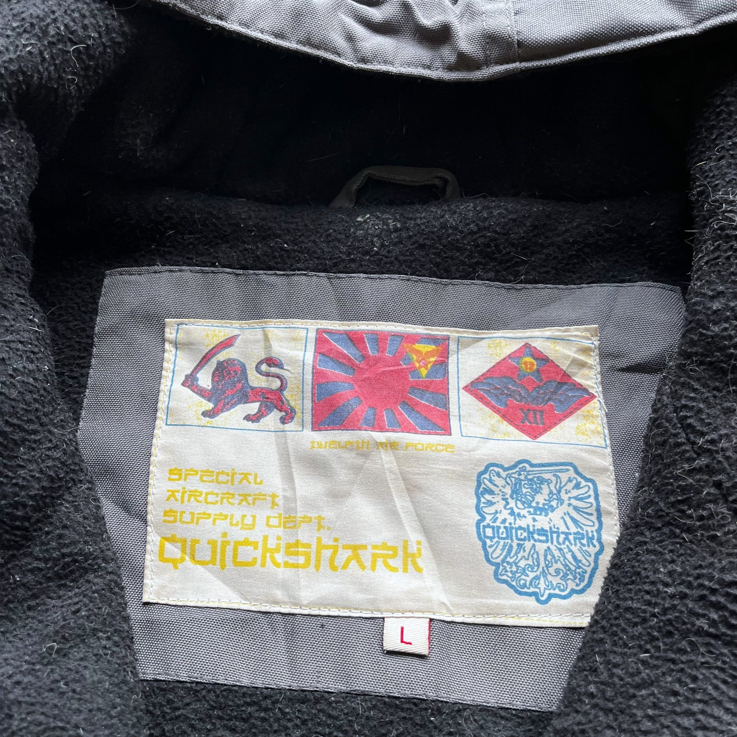 Quickshark label stitched inside of men's vintage Y2K special aircraft supply grey utility jacket with back spell out.