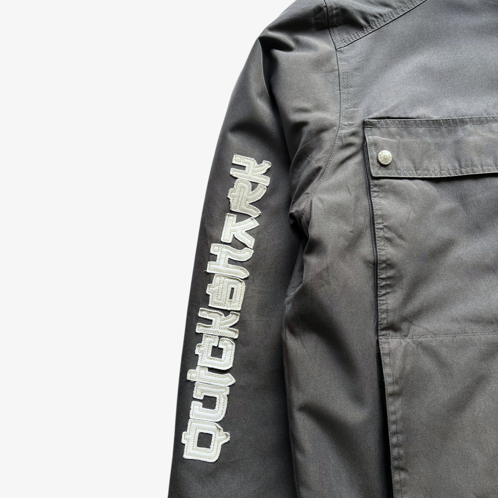 Spell out logo on sleeve of men's vintage Y2K Quickshark special aircraft supply grey utility jacket.