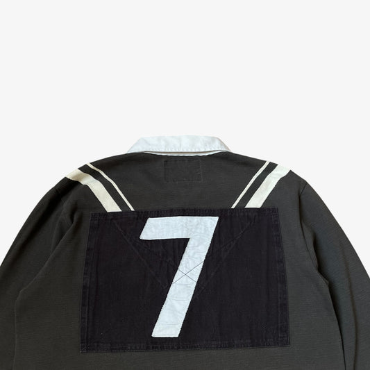 Close up of embroidered 7 on the back of vintage Y2K men's Ralph Lauren grey rugby shirt.