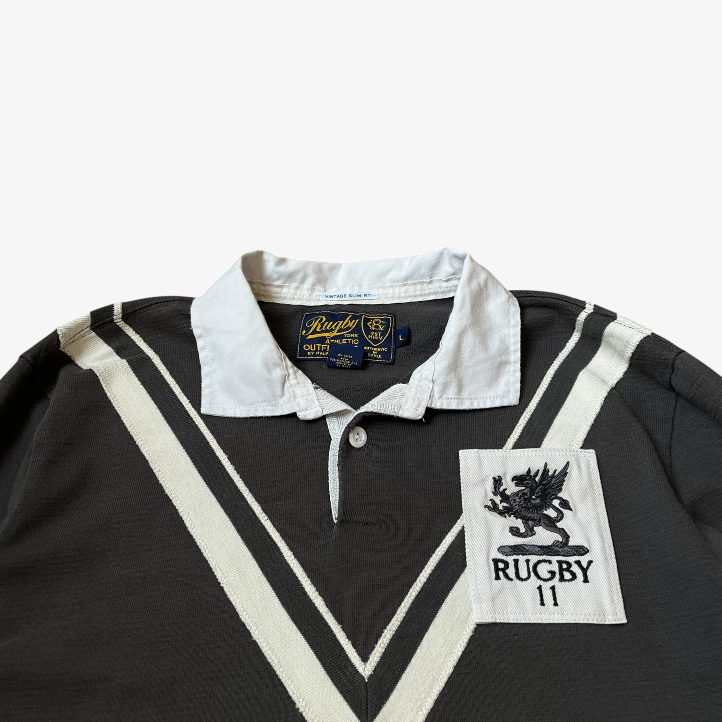 Close up of embroidered crest on vintage Y2K men's Ralph Lauren grey rugby shirt.