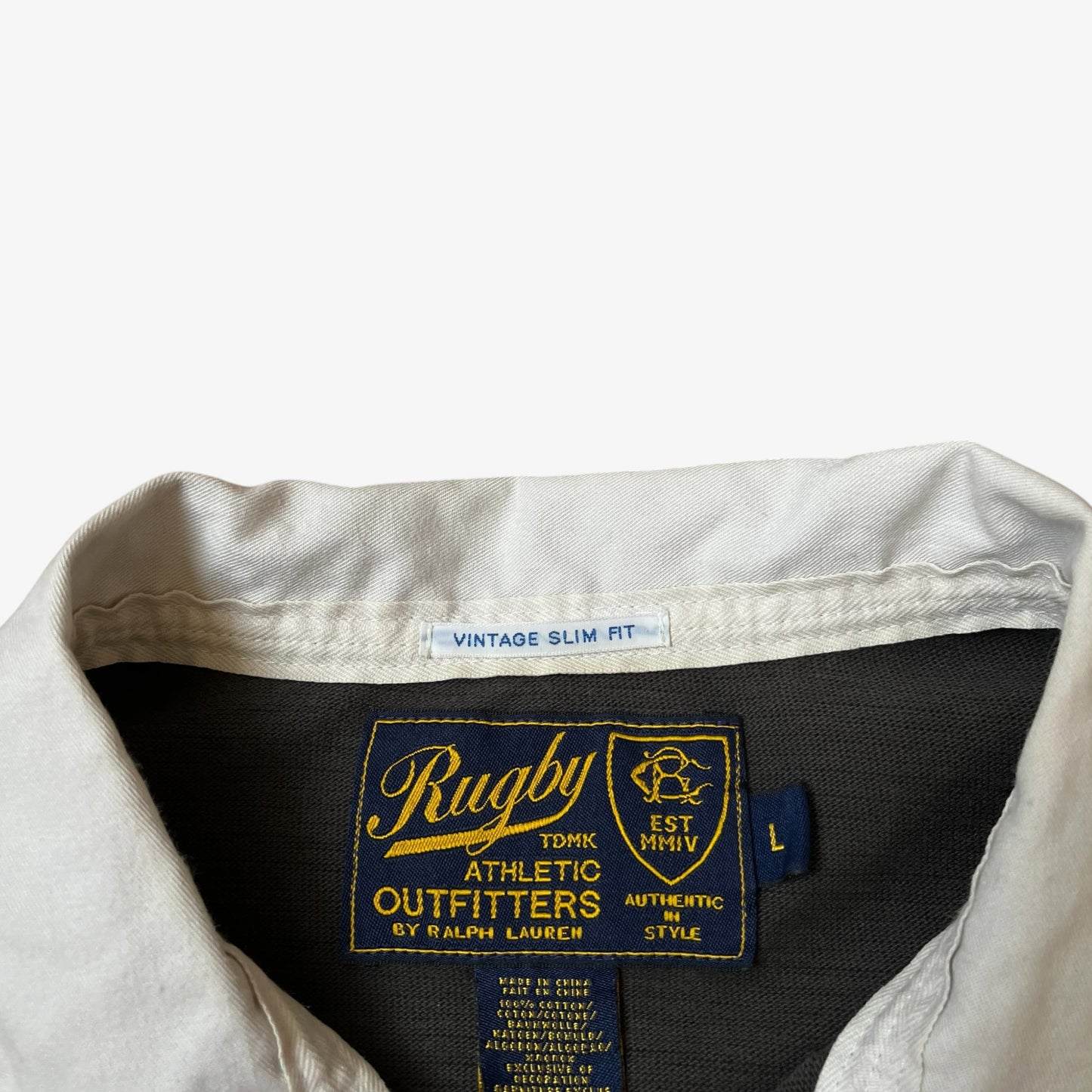 Vintage Y2K Ralph Lauren rugby label inside of a grey rugby shirt.