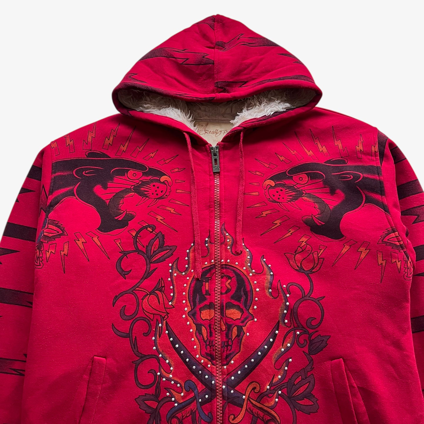 Logo on vintage Y2K men's Really Point rhinestone skull and panther double sided print red jacket.