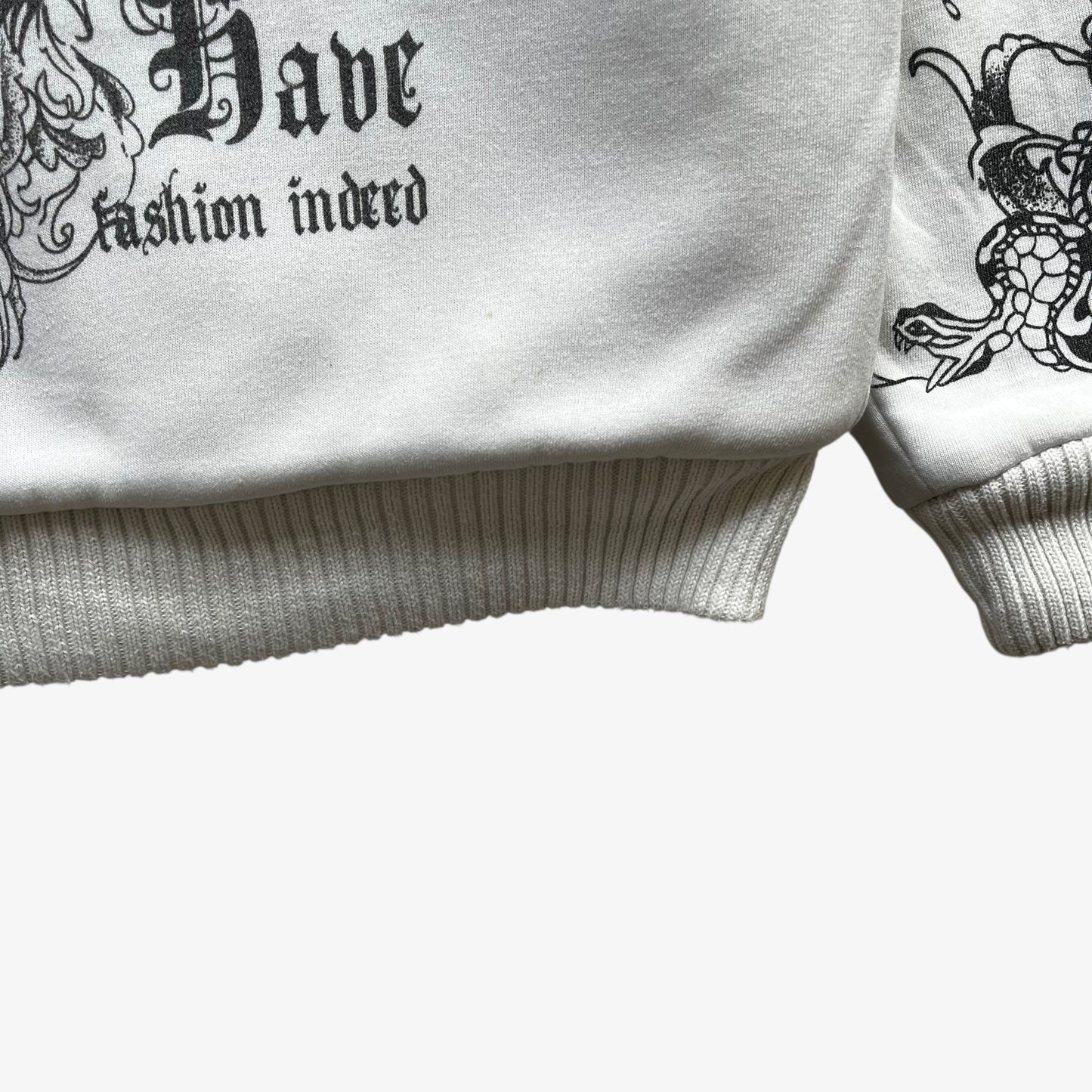Ribbed hem of vintage Y2K men's Really Point skull and snake double sided print white hooded jacket with sherpa lining.