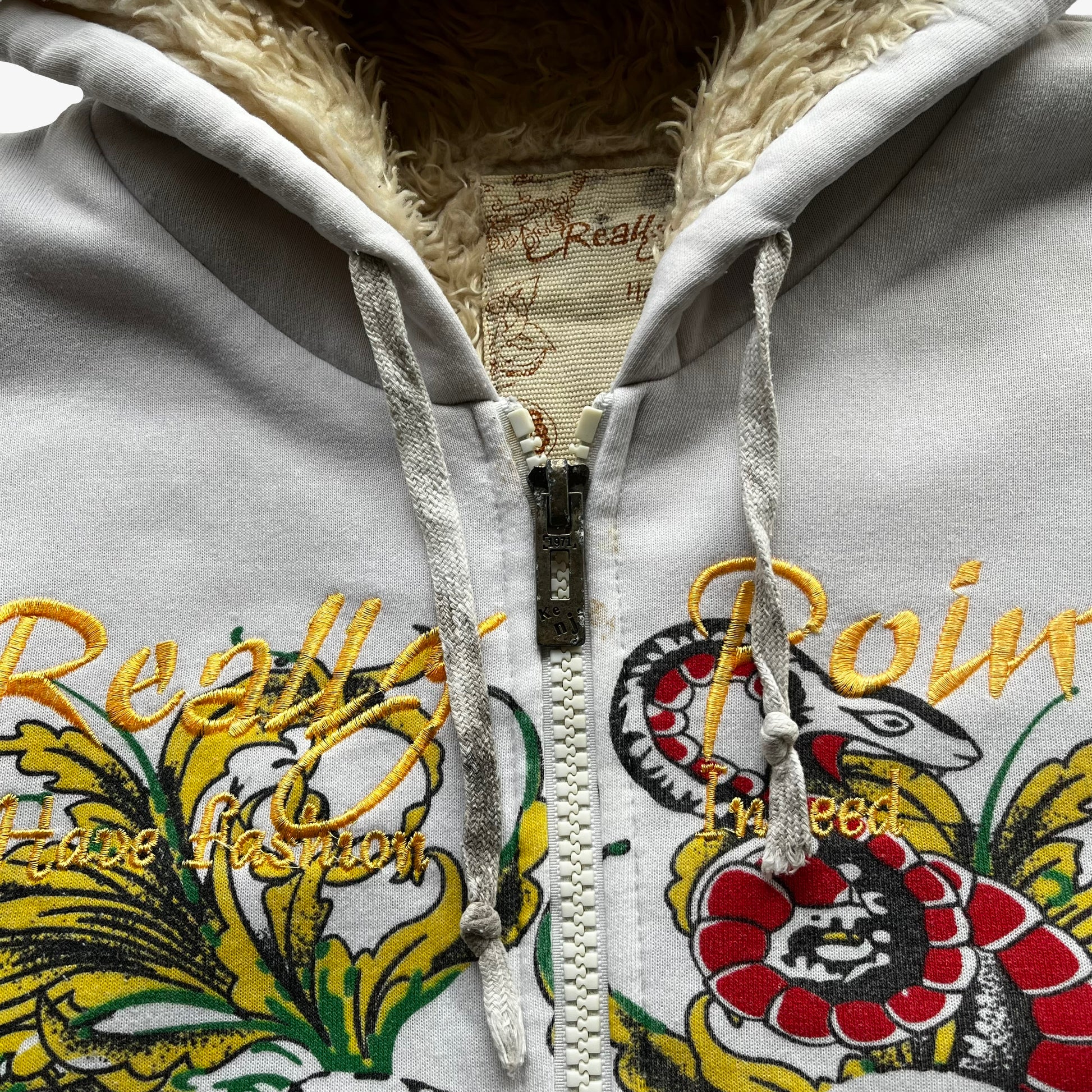 Metal zipper of vintage Y2K men's Really Point skull and snake double sided print white hooded jacket with sherpa lining.