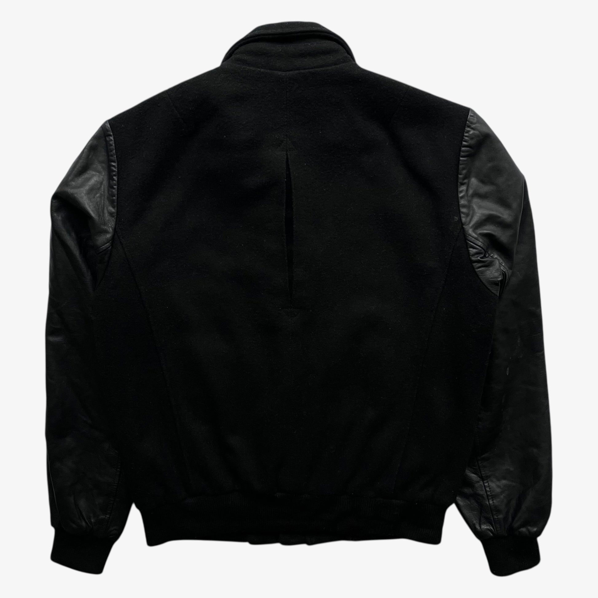 Back of vintage Religion black wool and leather varsity jacket on a white background.