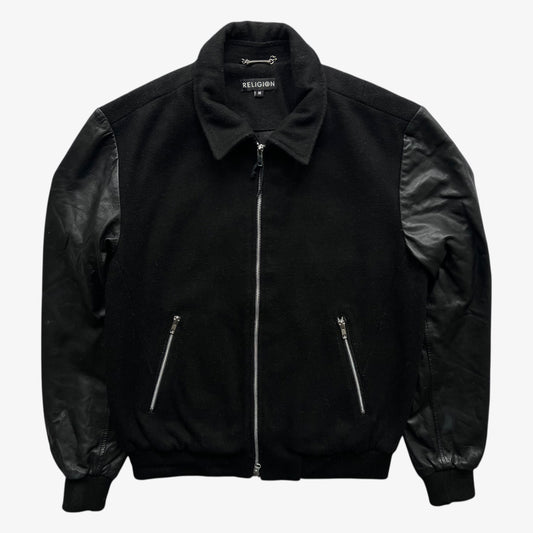 Vintage Religion black wool and leather varsity jacket on a white background.