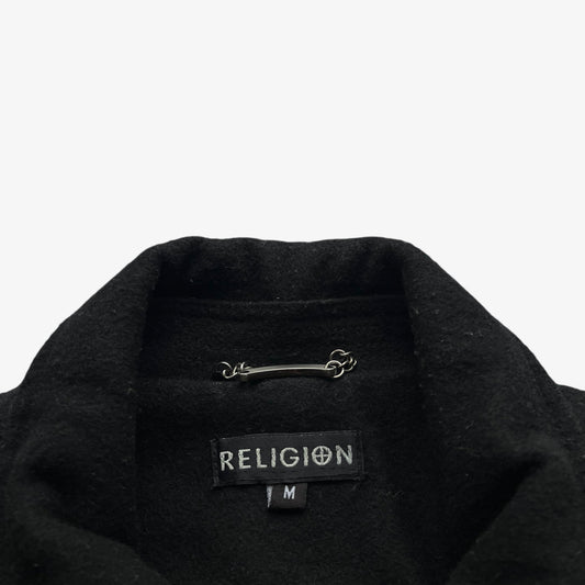 Religion label stitched inside of a men's black wool and leather varsity jacket.