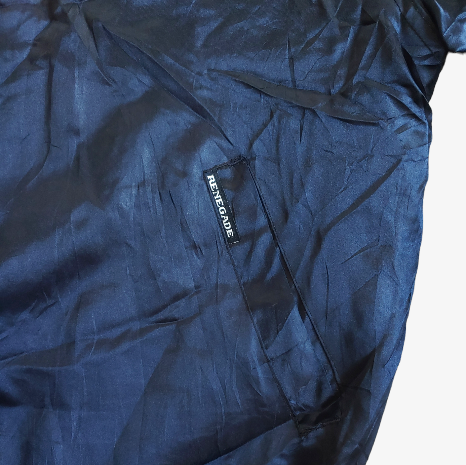 Tag on navy blue and red Renegade New York embroidered spell out varsity jacket.