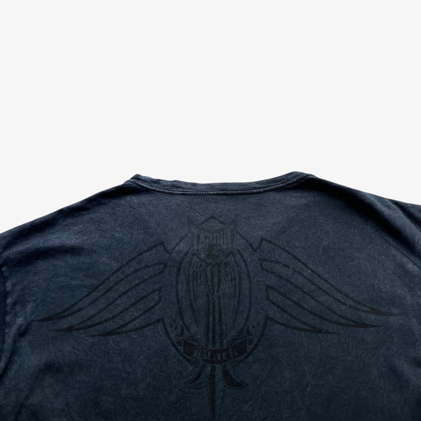 Close up of back print logo on a vintage Y2K men's Tapout t-shirt.