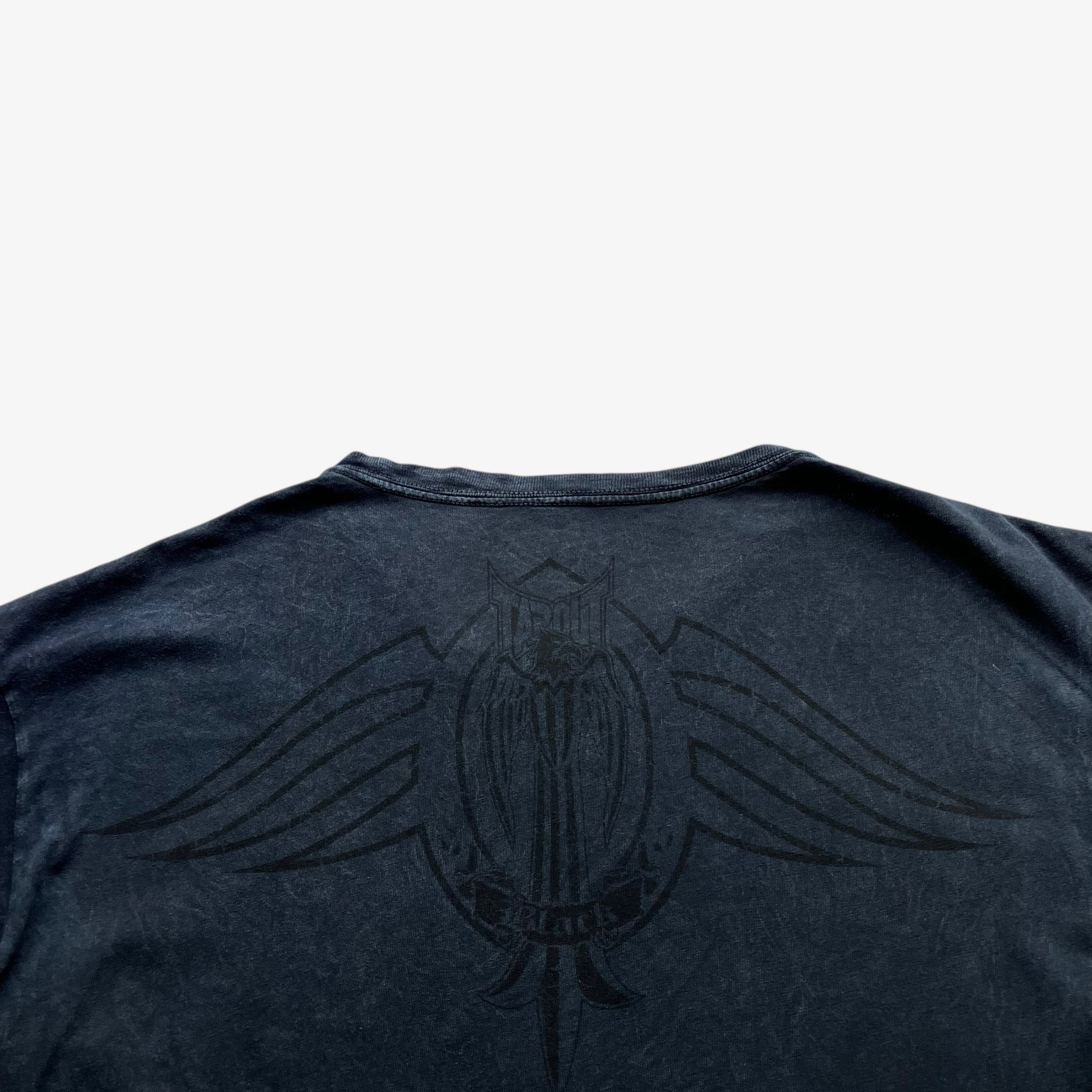 Close up of back print logo on a vintage Y2K men's Tapout t-shirt.