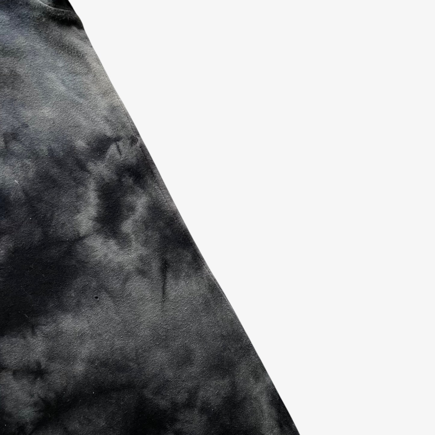 Close up of wear on the side of a vintage Y2K men's Tapout tie dye t-shirt.