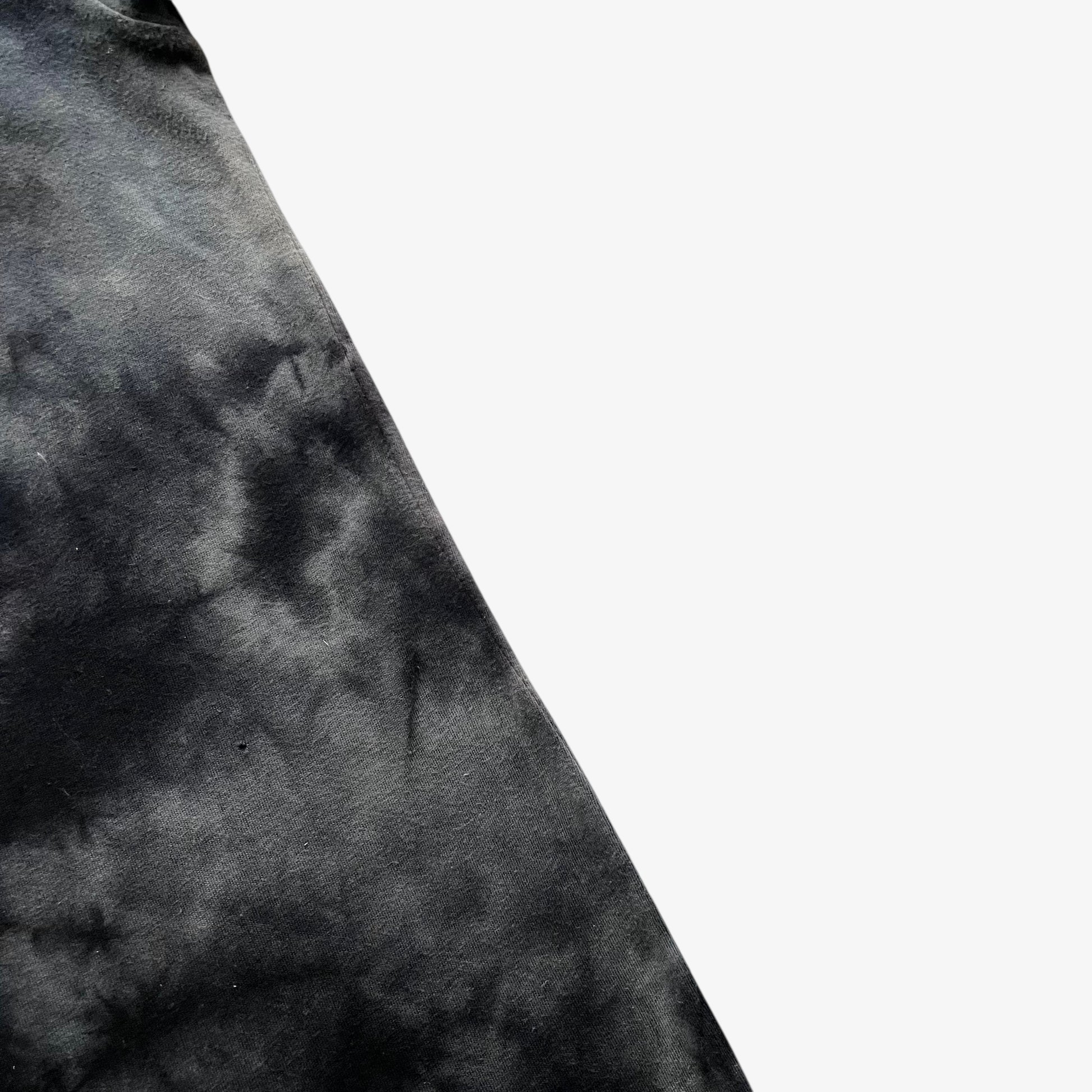 Close up of wear on the side of a vintage Y2K men's Tapout tie dye t-shirt.