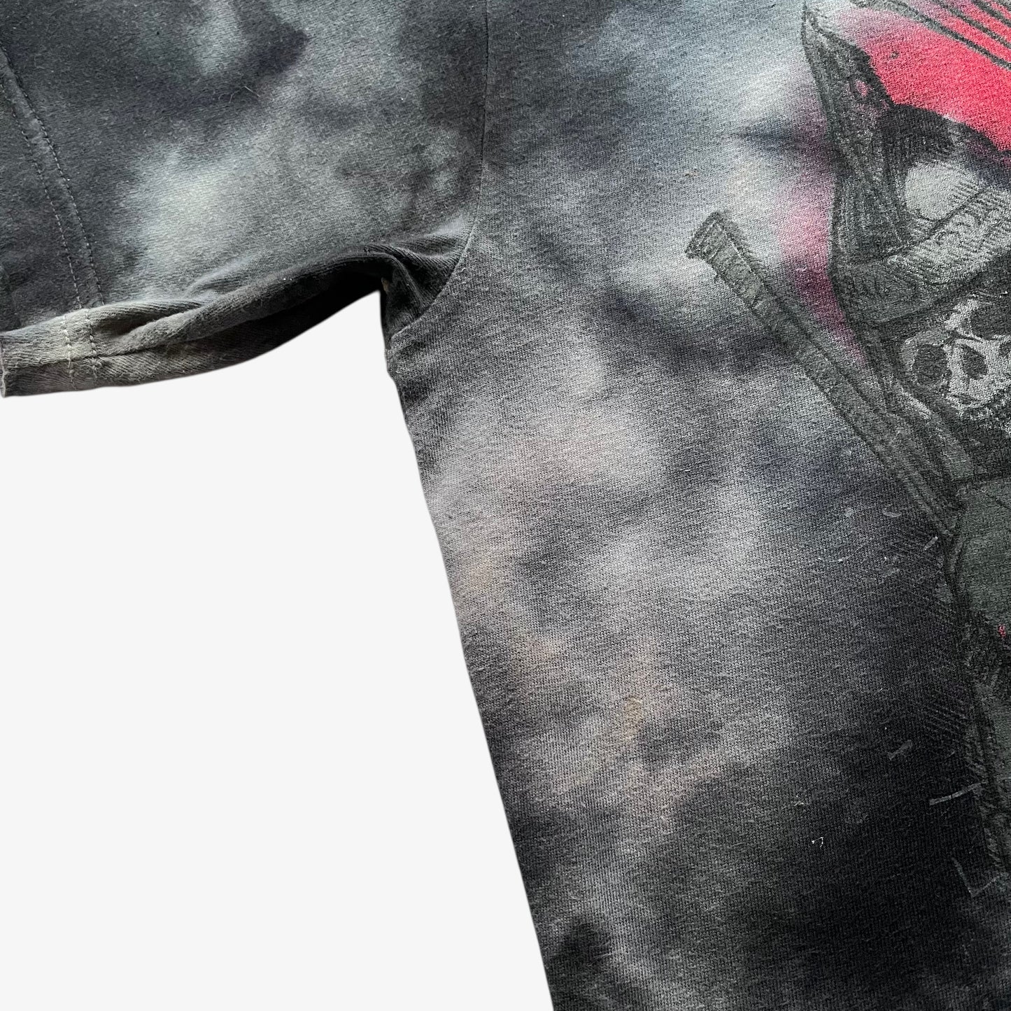 Close up of a zombie samurai print on a vintage Y2K men's Tapout tie dye t-shirt.