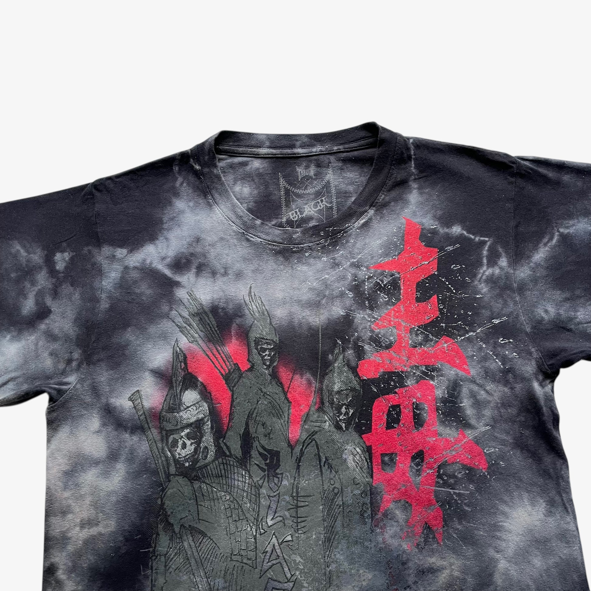 Close up of a skull samurai and tie dye print on a vintage Y2K men's Tapout t-shirt.