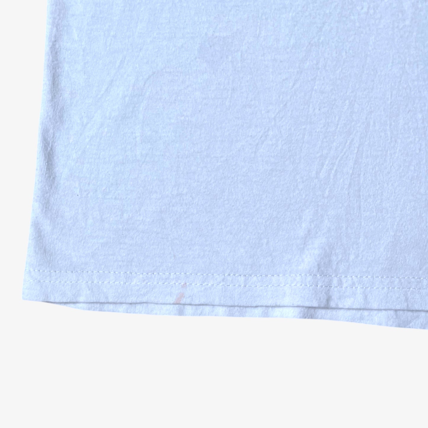 Hem of vintage Y2K men's The Hundreds Gigi woman print white t-shirt.