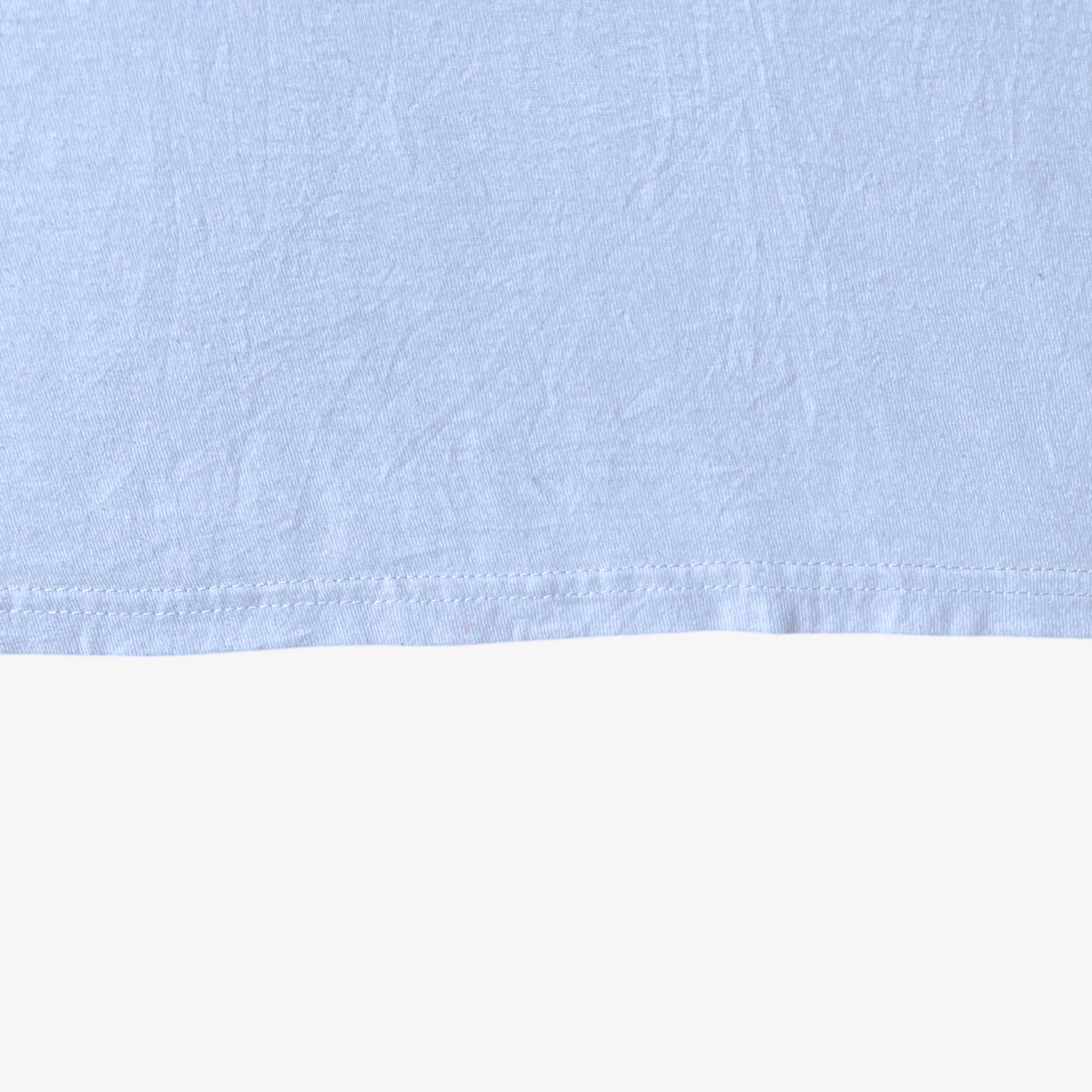 Hem wear on vintage Y2K men's The Hundreds Gigi woman print white t-shirt.