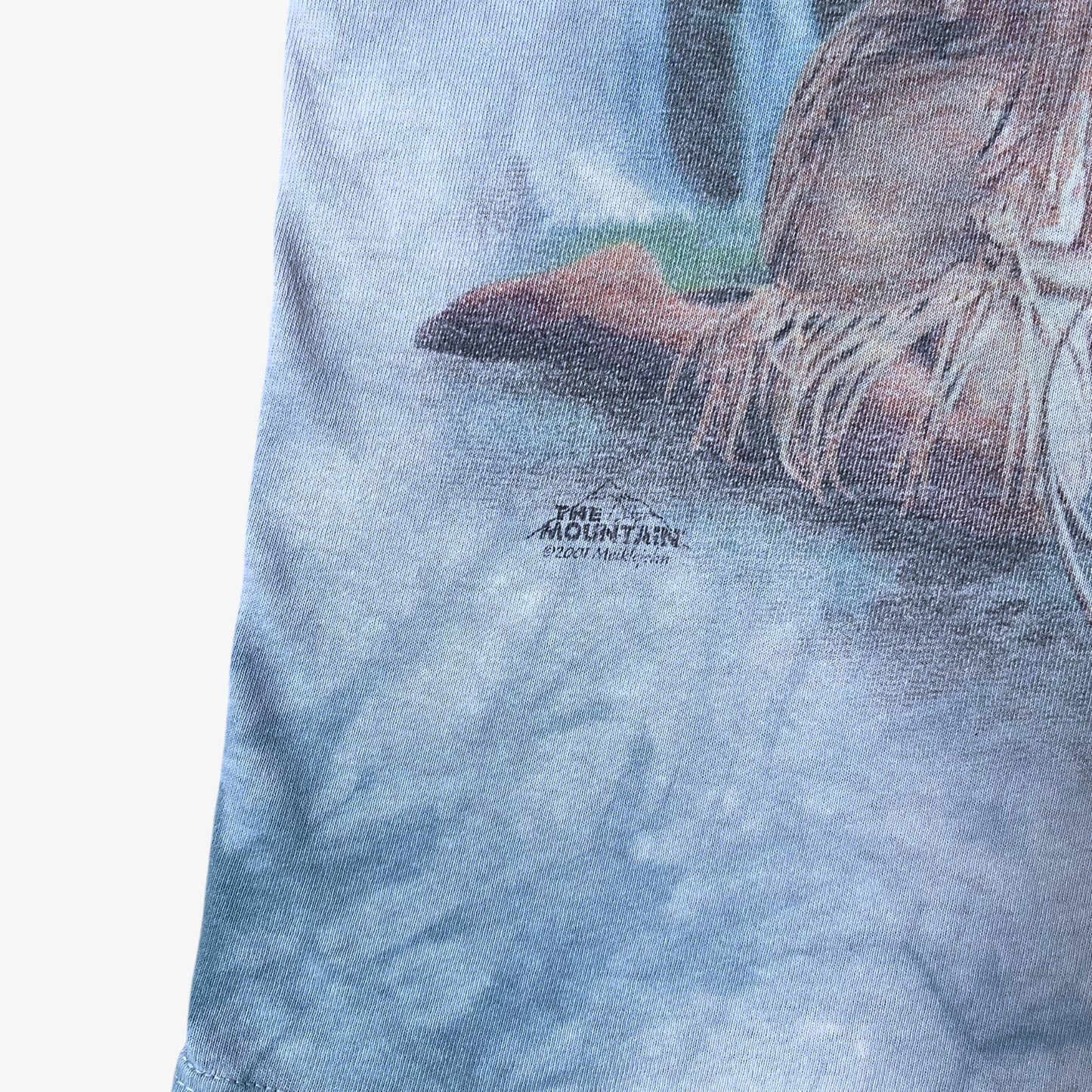 Printed 2001 logo on vintage Y2K The Mountain dreams of wolf spirit blue tie dye t-shirt.