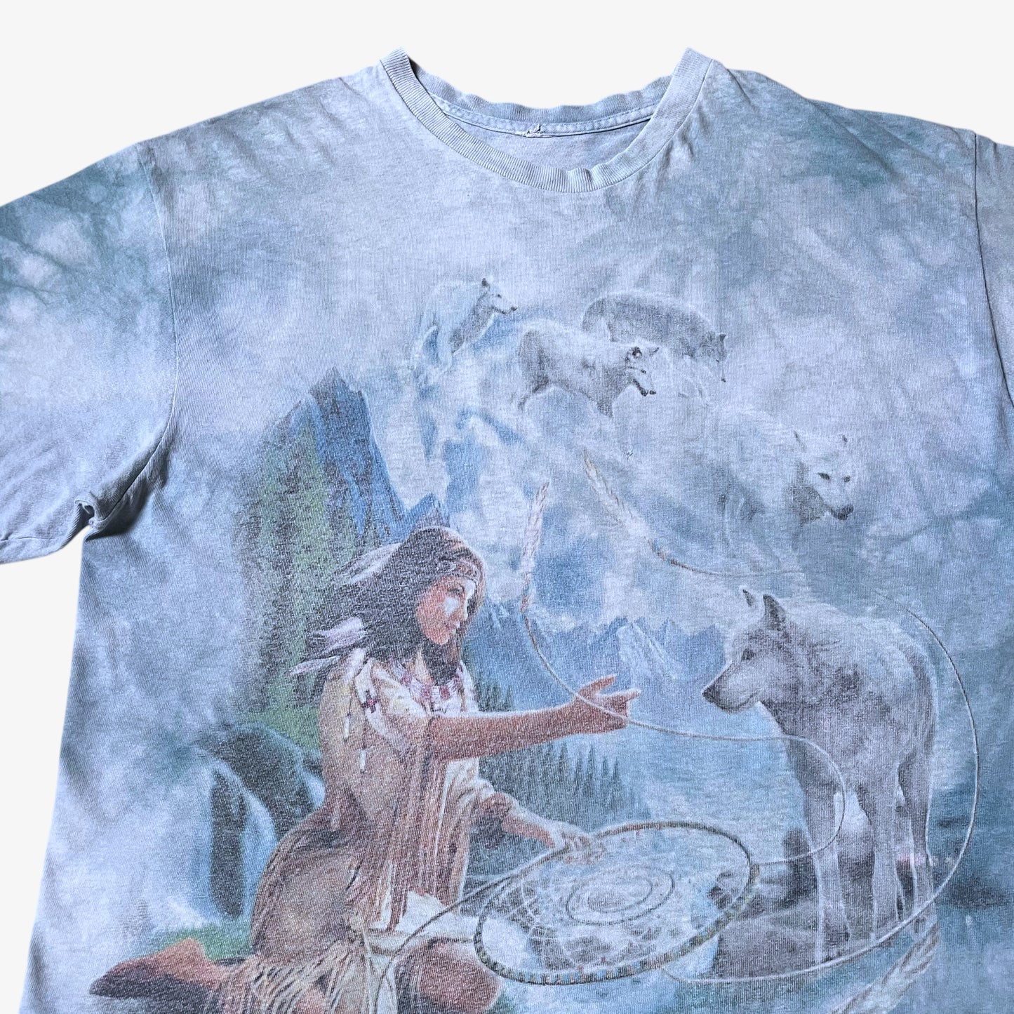 Close up of dreams of wolf spirit print on a vintage Y2K The Mountain blue tie dye t-shirt.