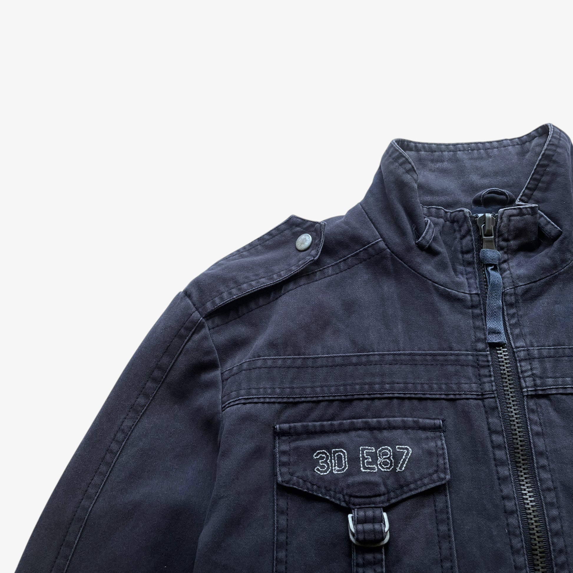 Embroidered logo on vintage Y2K men's US Army 3D E87 faded navy utility jacket.