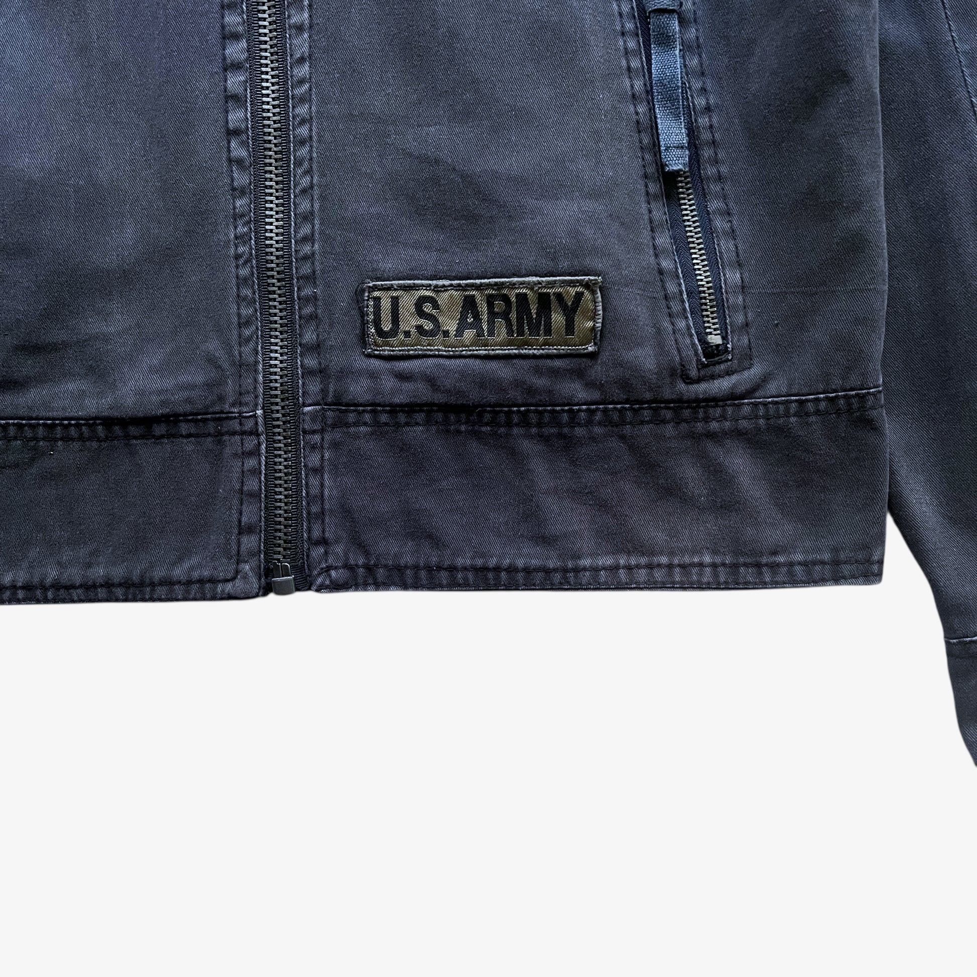 Embroidered tag on vintage Y2K men's US Army 3D E87 faded navy utility jacket.