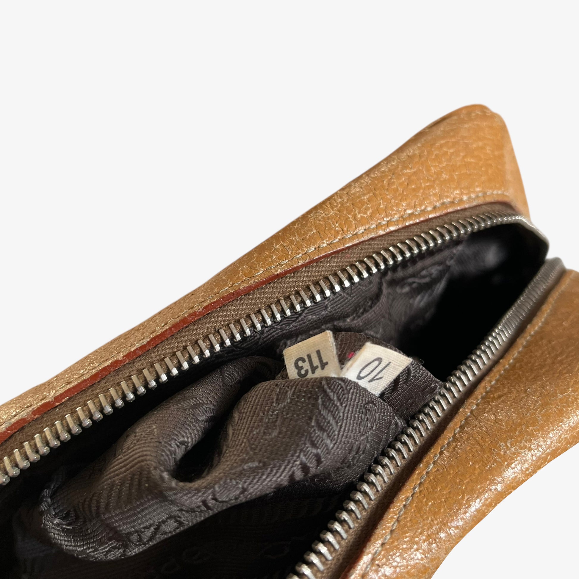 Prada 113 authentic label stitched inside of vintage Y2K Cinghiale sport brown leather Bauletto shoulder bag.