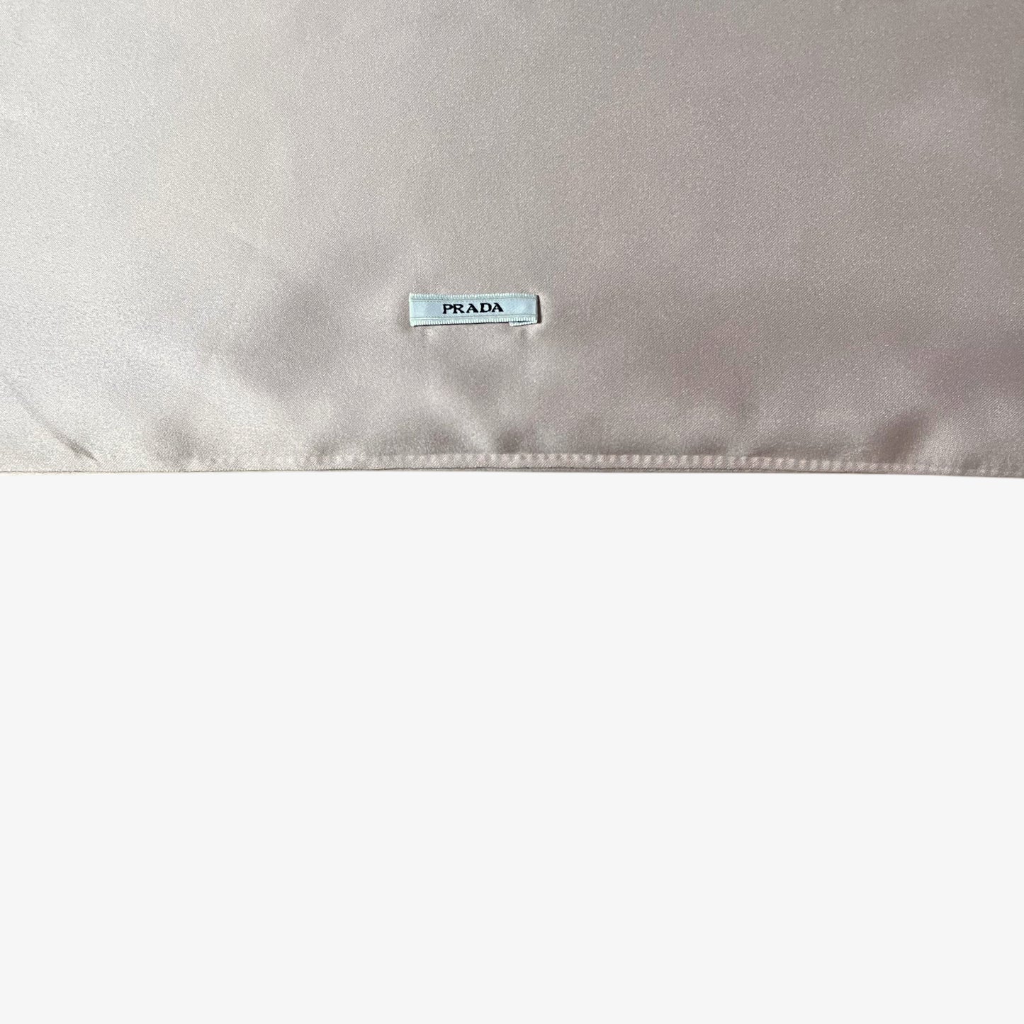 Stitched Prada logo on vintage Y2K pale pink dust bag.