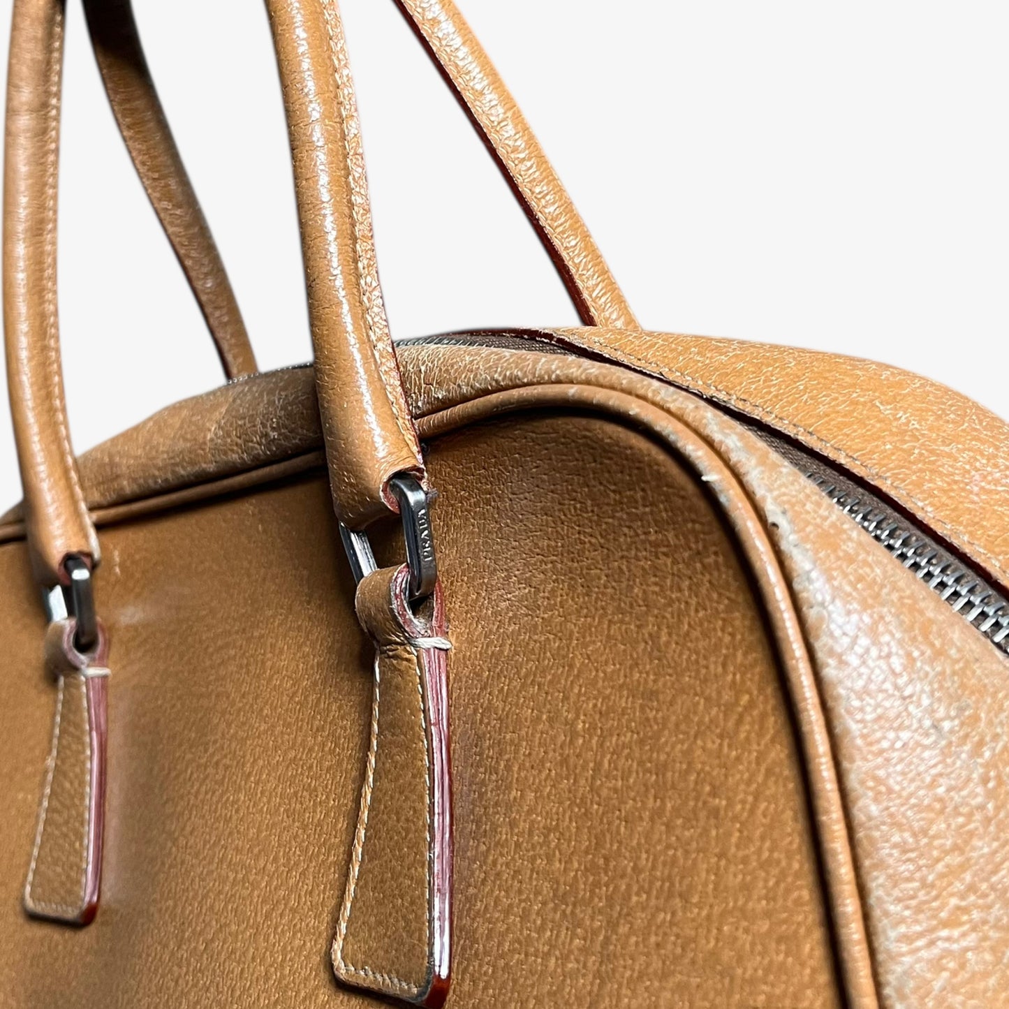 Engraved Prada logo on vintage Y2K Cinghiale sport brown leather Bauletto shoulder bag.