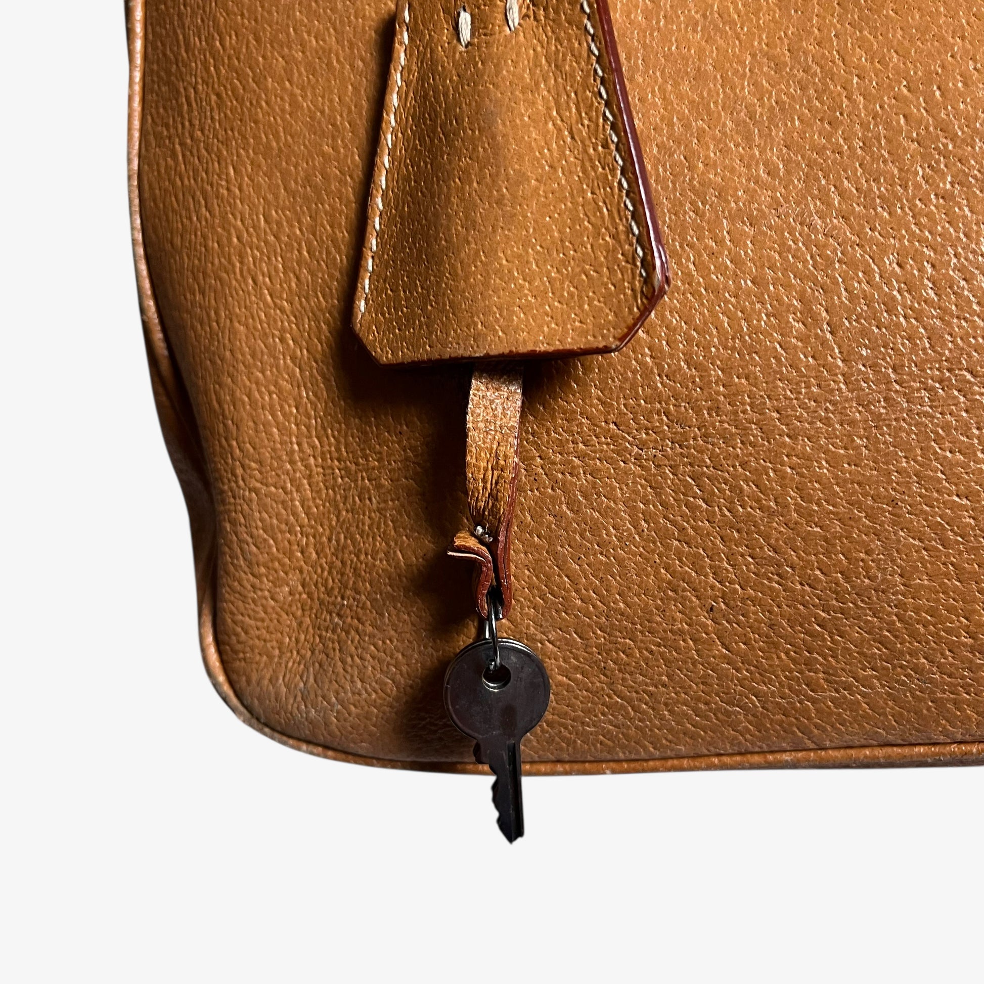 Key charm on vintage Y2K Prada Cinghiale sport brown leather Bauletto shoulder bag.