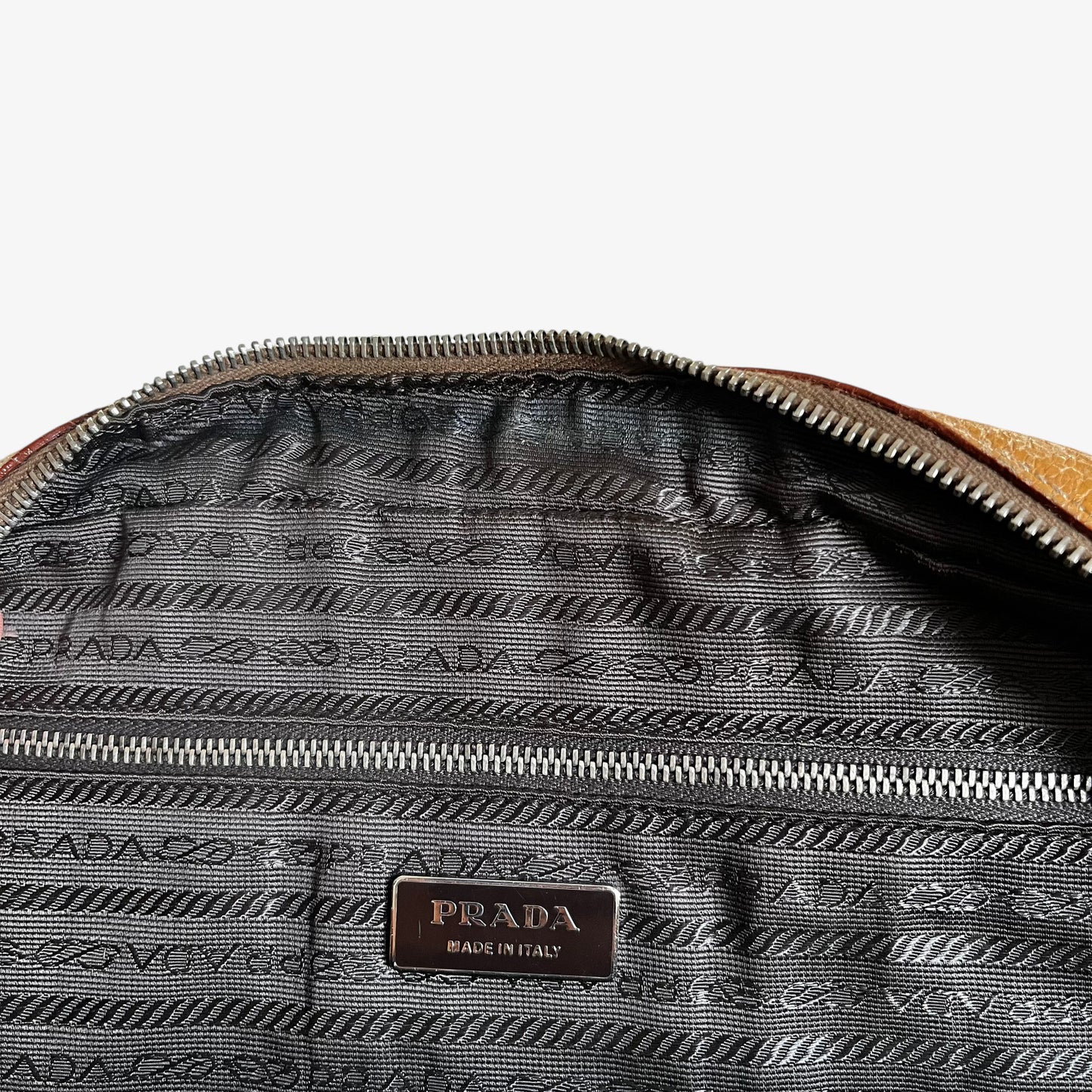 Prada logo stitched inside of vintage Y2K Cinghiale sport brown leather Bauletto shoulder bag.