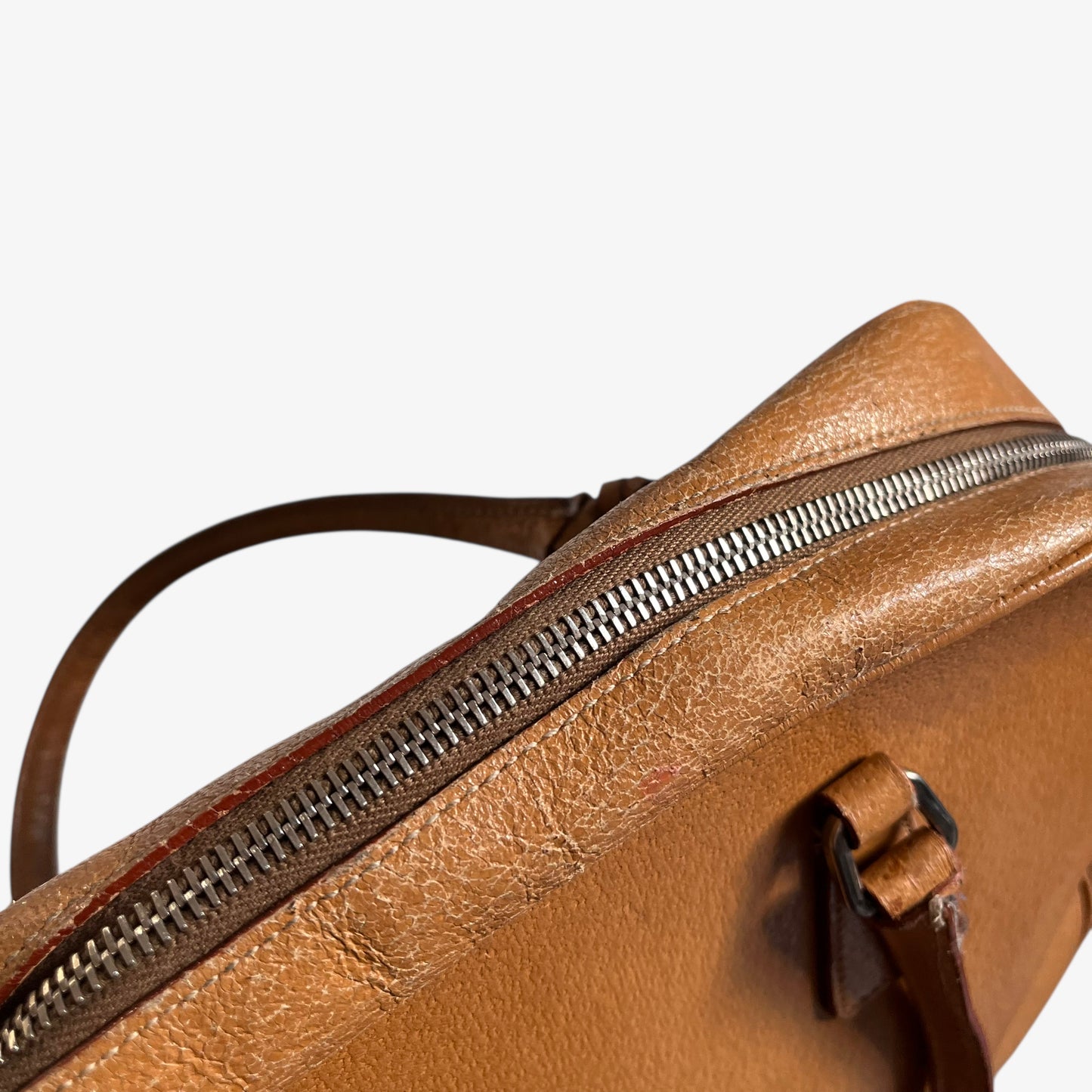 Wear on the zipper of vintage Y2K Prada Cinghiale sport brown leather Bauletto shoulder bag.