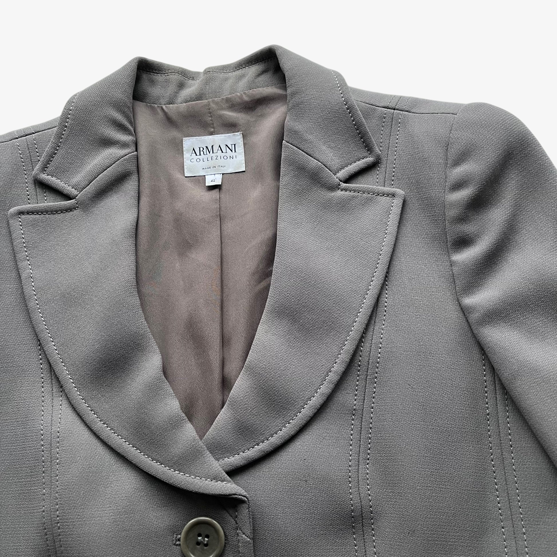 Close up of collar on a vintage Y2K women's Armani Collezioni grey single breasted blazer.