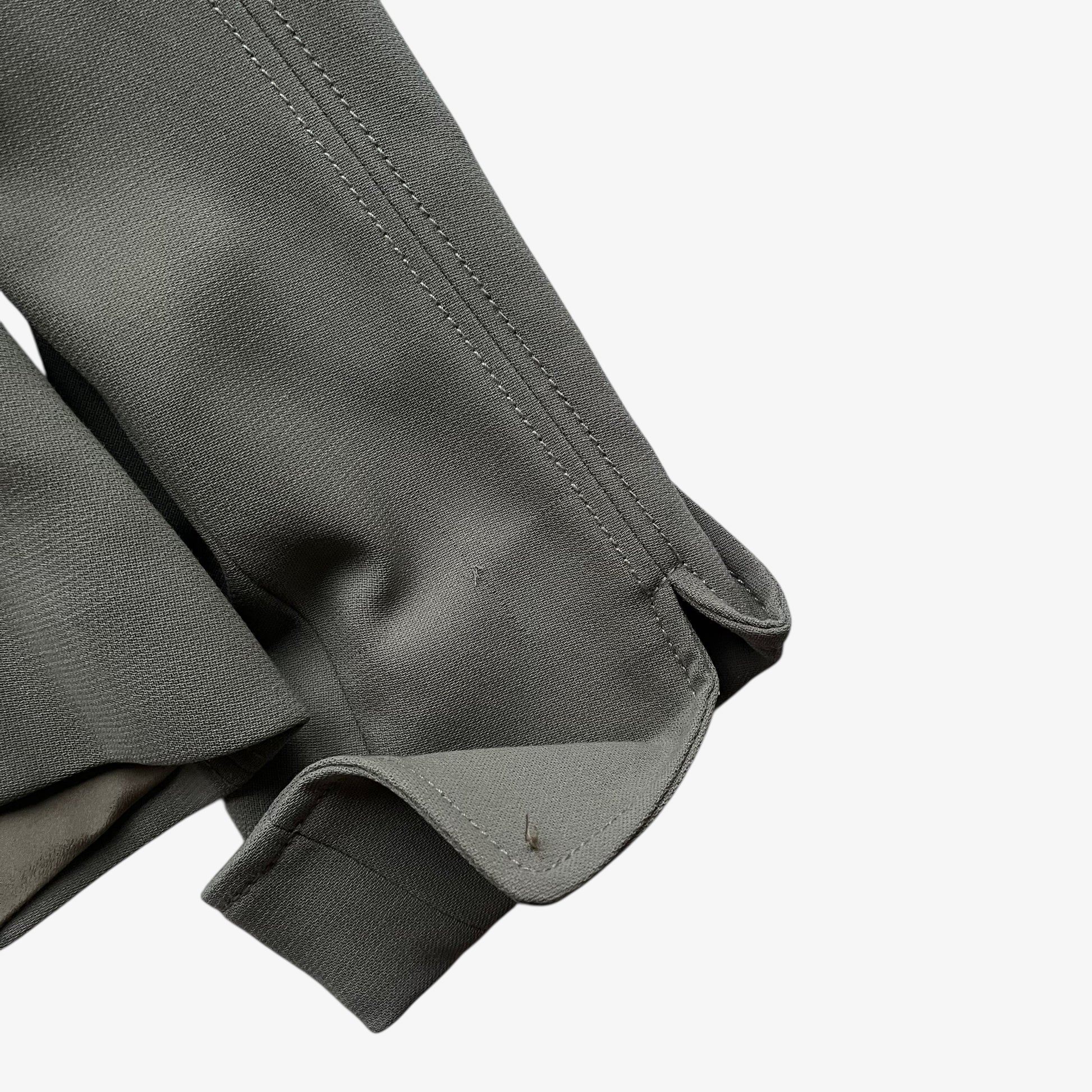 Wear on the cuff of a vintage Y2K women's Armani Collezioni grey single breasted blazer.