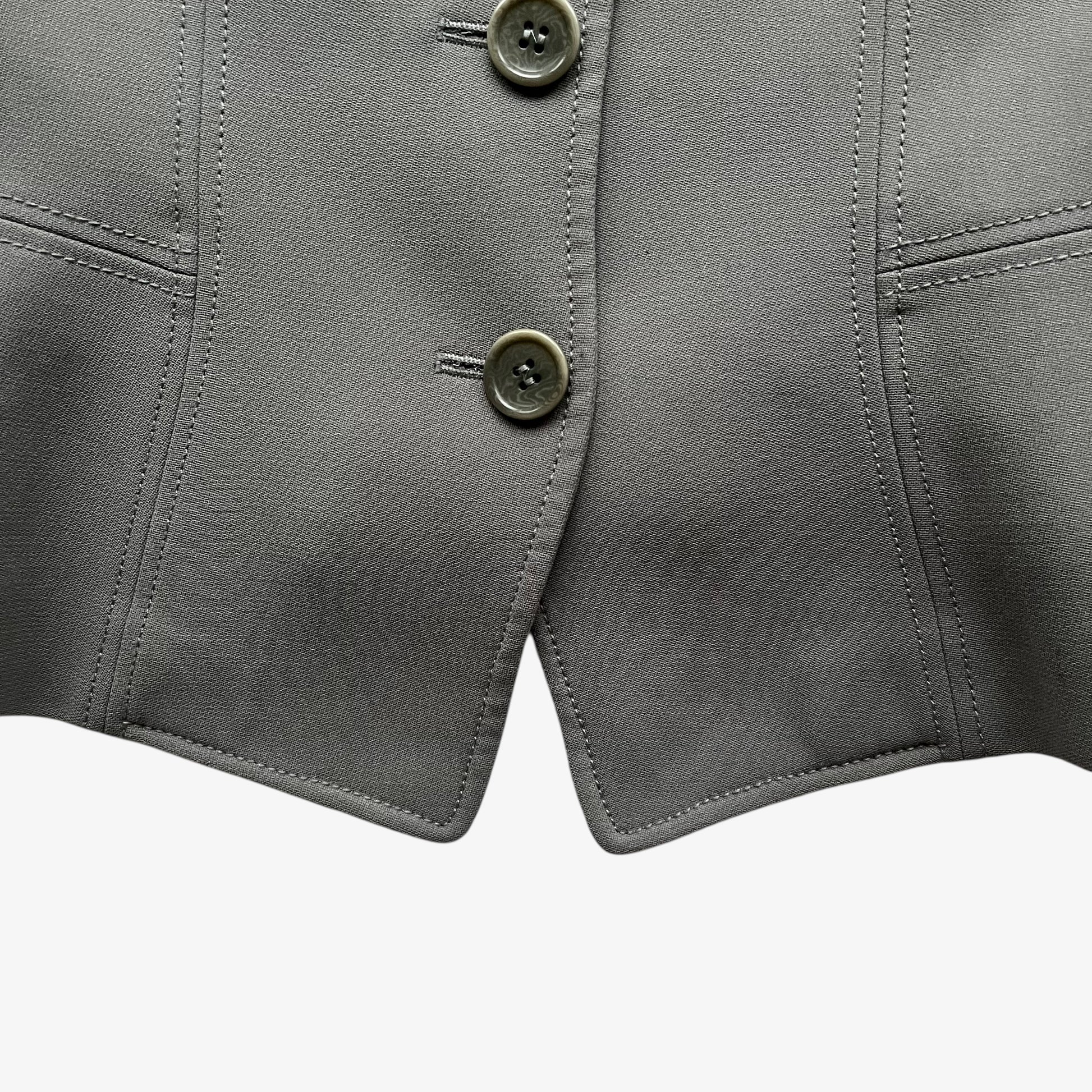 Close up of hem of vintage Y2K women's Armani Collezioni grey single breasted blazer.